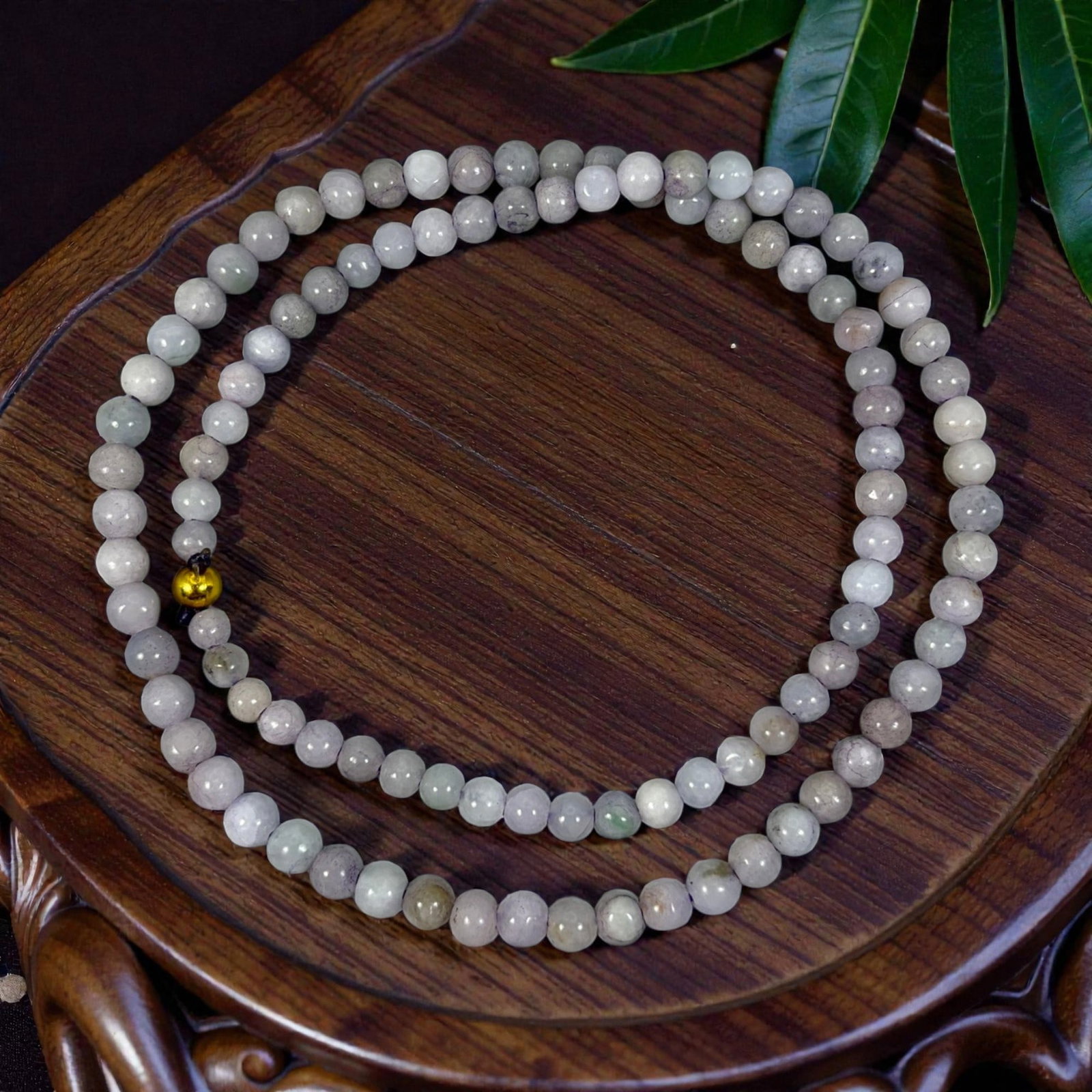 Natural Burmese Lavender Type A Jadeite Bead Necklace, 95XE: A continuous strand of polished jadeite beads, each of uniform spherical form, displaying soft greyish-white and pale lavender tones with natural mineral inclusions and subtle variations in translucen