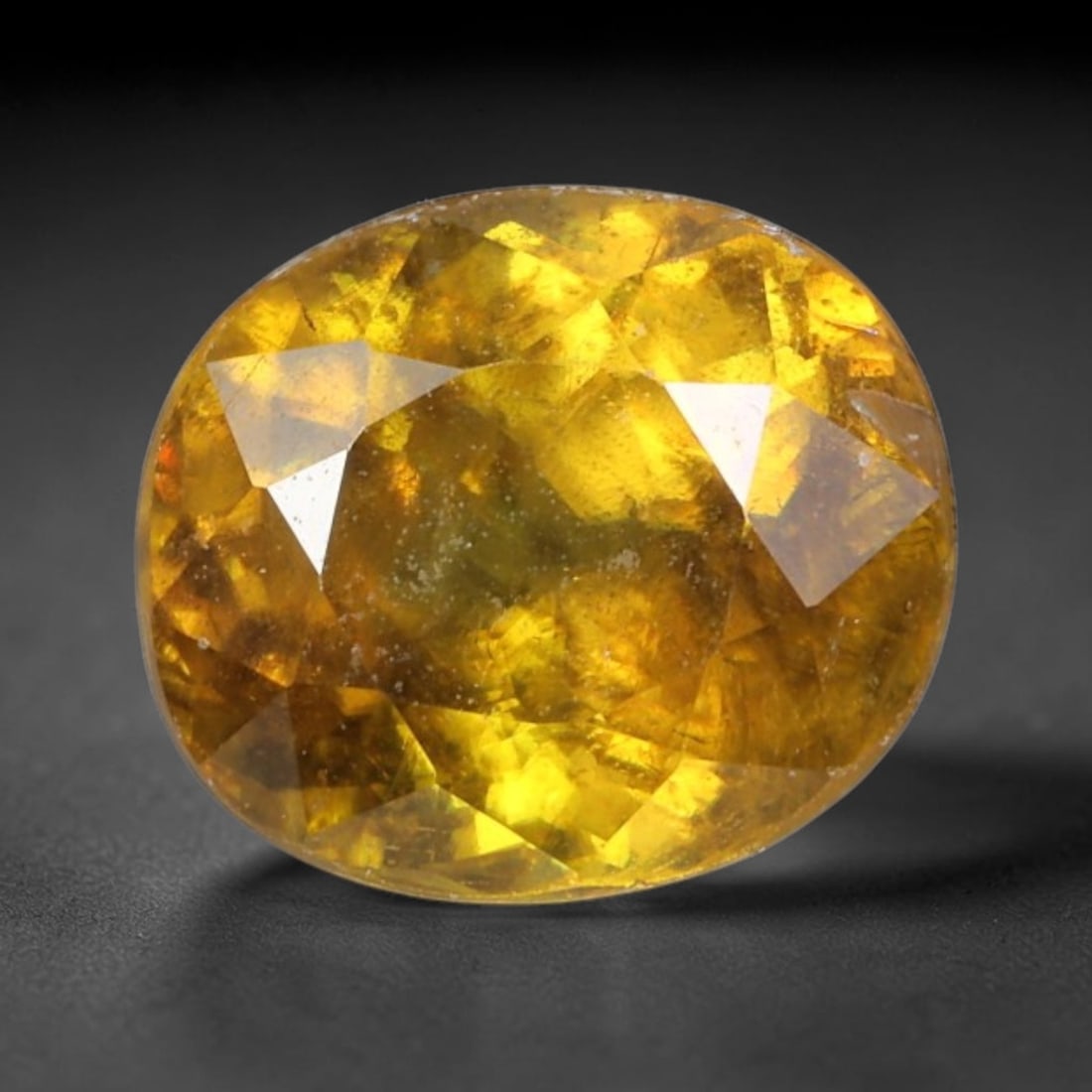 2.03 Carats Golden Yellow Oval Sphene - Natural Loose Gemstone, 92XY: This vibrant oval sphene captivates with a rich, honeyed golden-yellow hue, brought to life by the gemstone's legendary dispersion. Measuring 7.8x6.9x4.8mm, the faceted cut unlocks intense fire, sendi