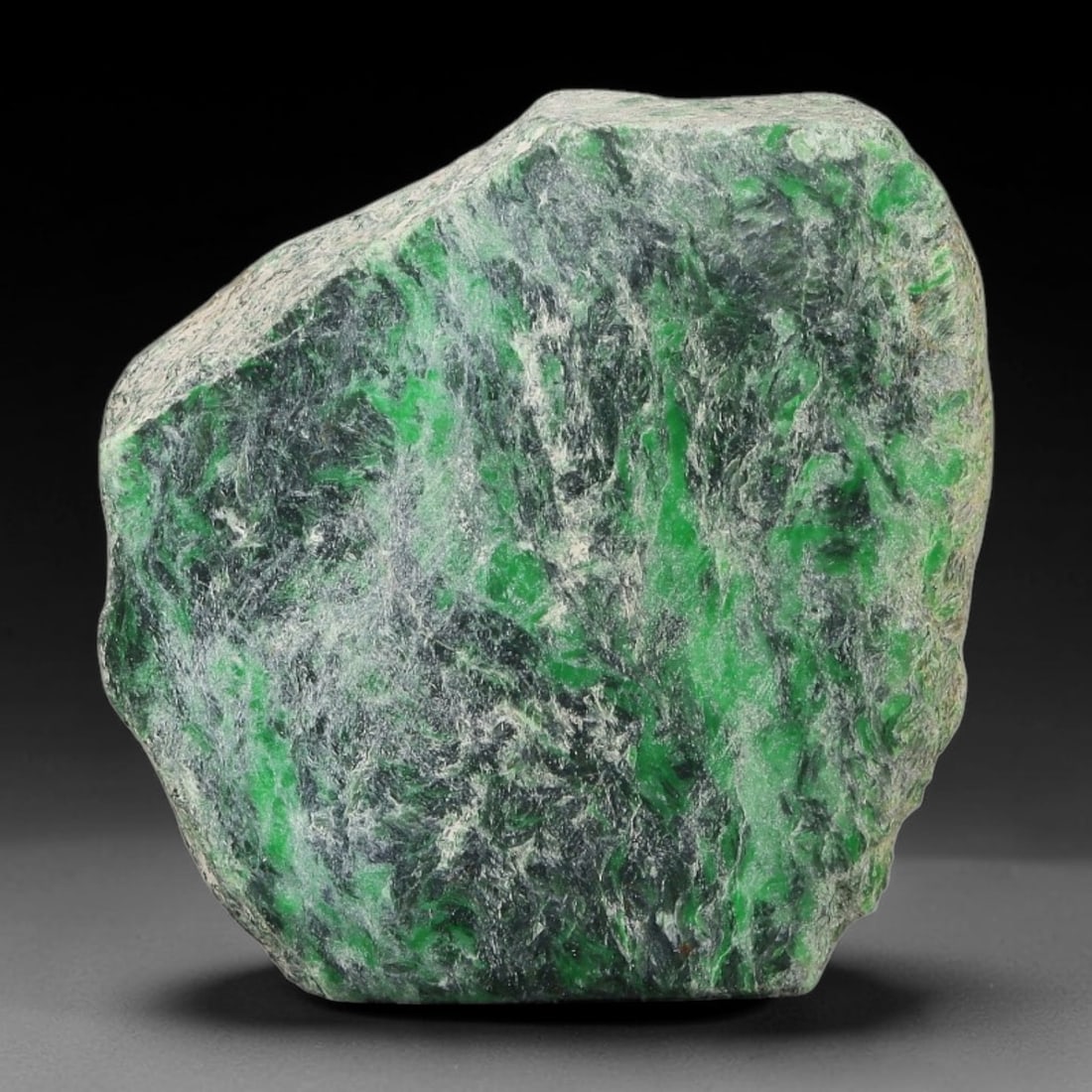 222ct Natural Type A Burmese Jadeite Jade Sliced Rough, 100YQ: This specimen is a sliced rough block of natural Type A Burmese jadeite jade. The interior displays natural colour zoning with visible mineral veining and crystalline patterns typical of unprocessed j
