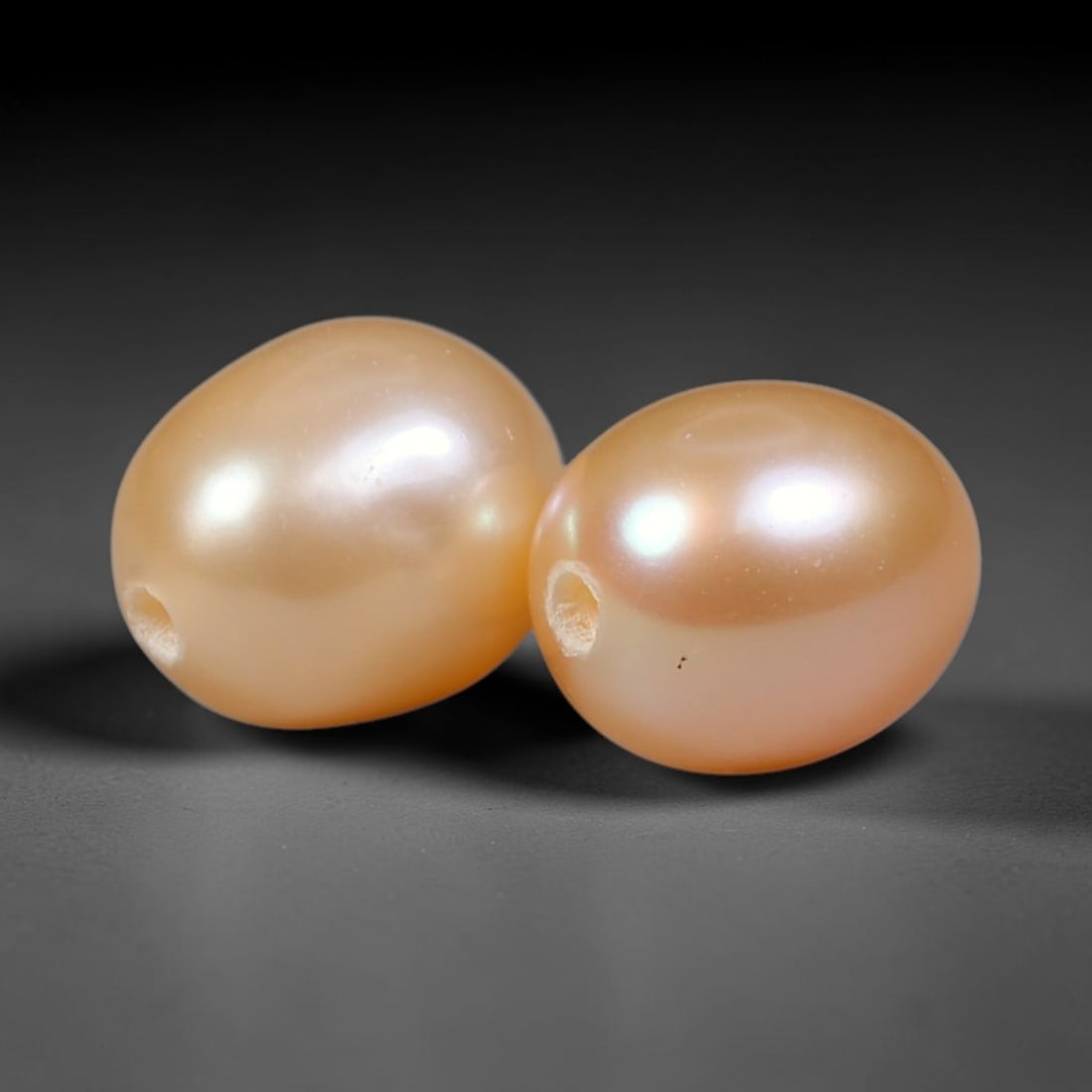 3.97ct Natural Peach Golden Orient Freshwater Egg Shape Pearl Pair, 63XZ: Matched pair of natural freshwater egg/oval pearls, uniform 7.4x6.2mm with clean through-drilled holes ready for jewelry setting. Each pearl features smooth silky nacre with a soft warm peach-gold bas