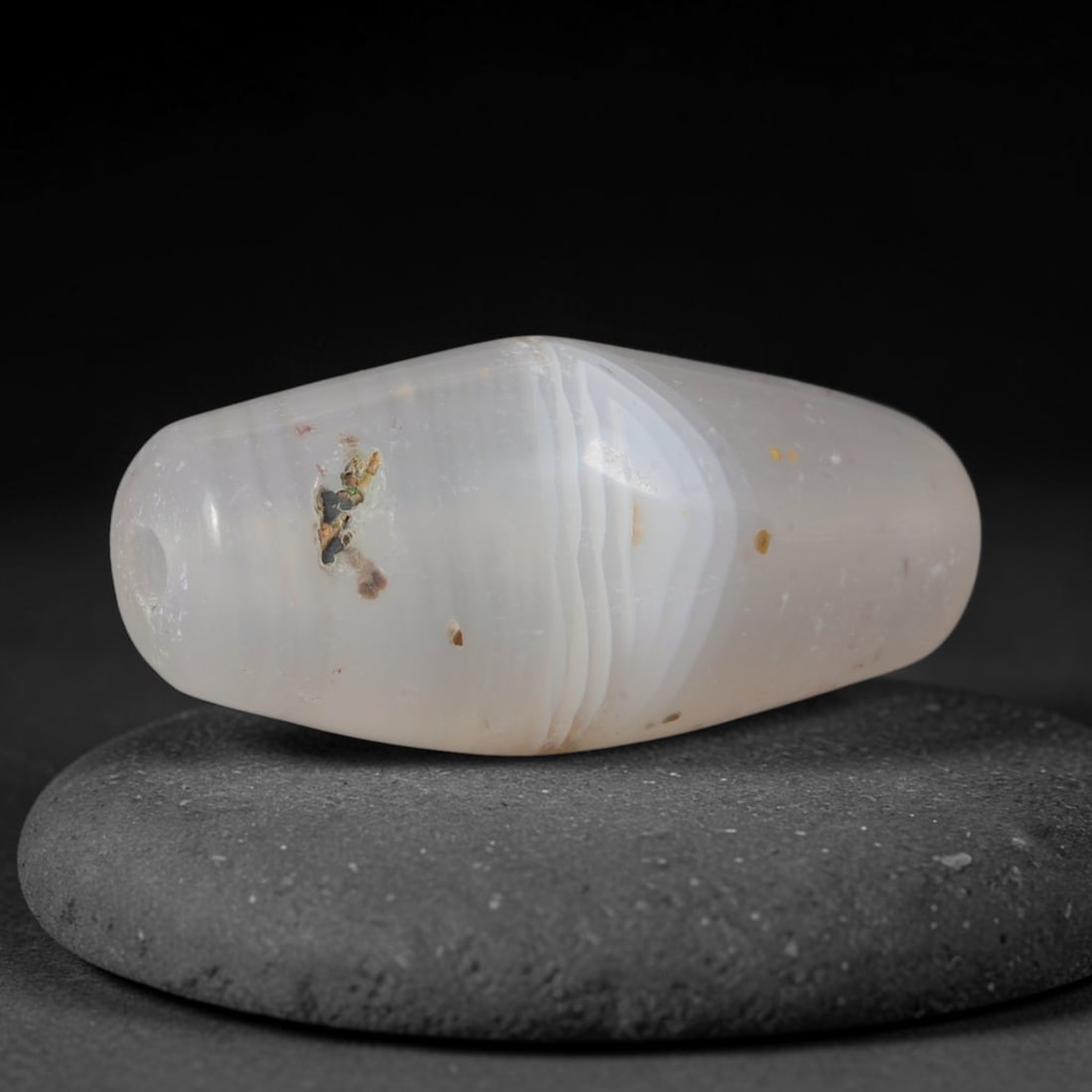 Ancient Gandhara Civilization Banded Agate Bicone Trade Bead (600 BCE - 500 CE), 93XD: This antique banded agate bicone bead originates from Gandhara Civilization, a revered cross-cultural Central Asian craft hub that produced polished layered chalcedony talismans for Buddhist monastic 