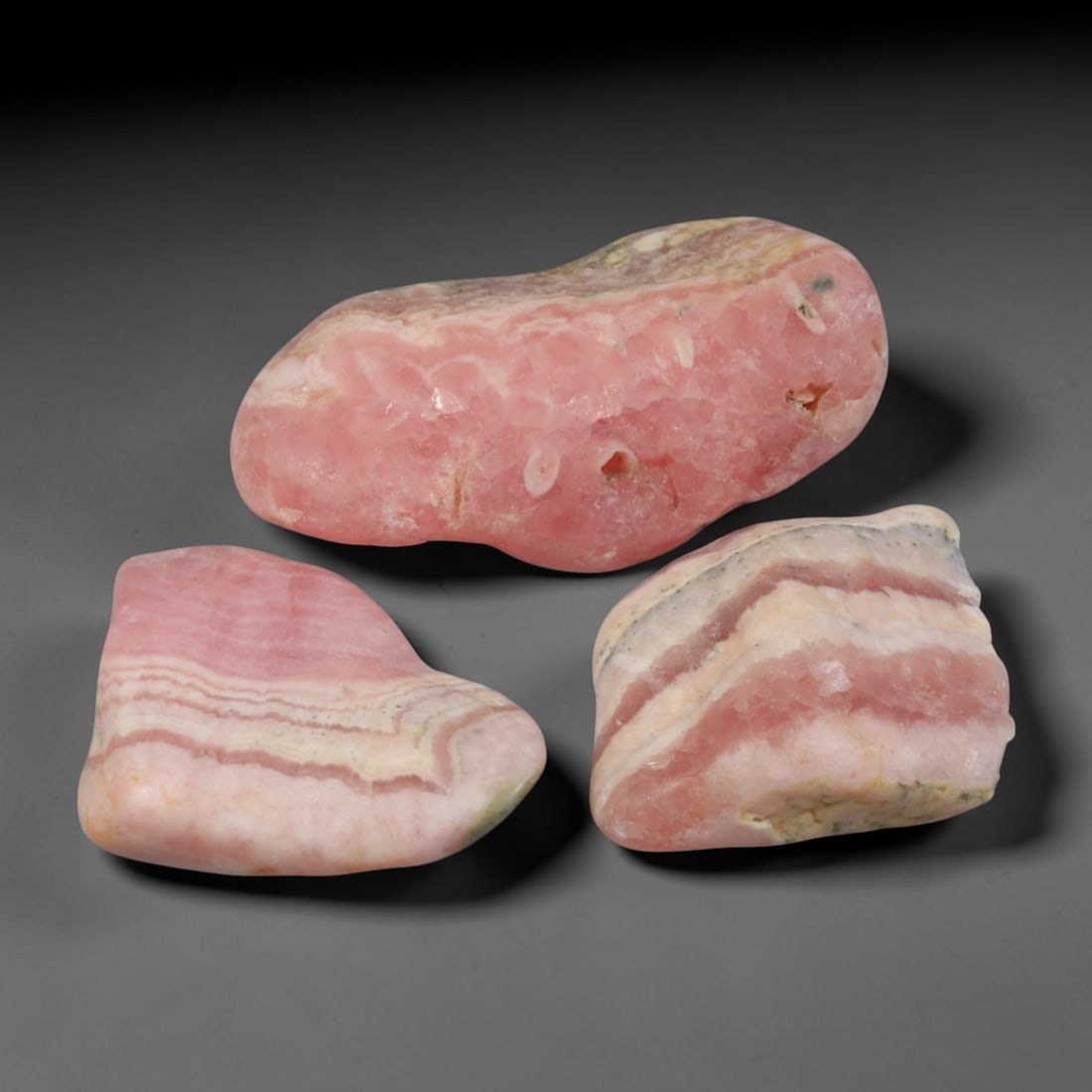 52ct 3pcs Natural Argentine Rhodochrosite Banded Tumbled Rough Set, 2YR: This listing features three individual tumbled rhodochrosite rough pieces sourced from Argentina Capillitas deposits, each showcasing distinct layered banding of soft rose pink, cream white and pale t