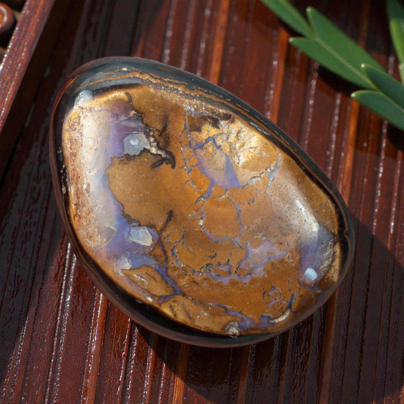 10.56 Carats Brown Matrix and Violet Vein Yowah Opal Cabochon - Natural Australian Stone, 45XM: This striking Yowah opal cabochon features a smooth, oval form with a rich brown ironstone matrix crisscrossed by delicate, iridescent violet veins of opal. The stone's polished surface enhances the c