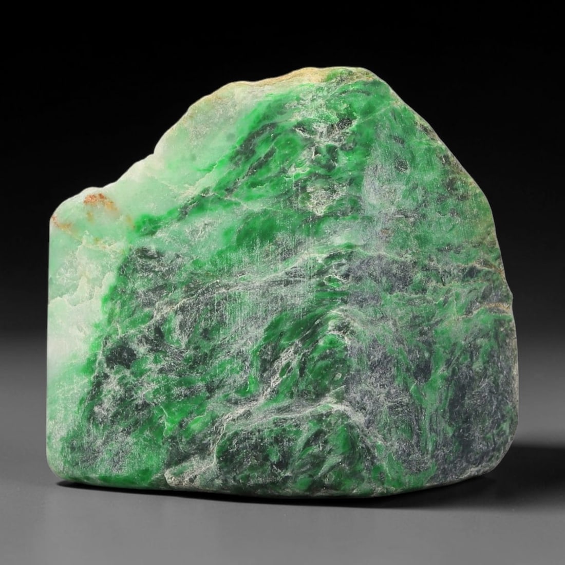 350ct Natural Type A Burmese Jadeite Jade Sliced Rough, 56YK: This specimen is a sliced rough block of natural Type A Burmese jadeite jade. The interior displays natural colour zoning with visible mineral veining and crystalline patterns typical of unprocessed j