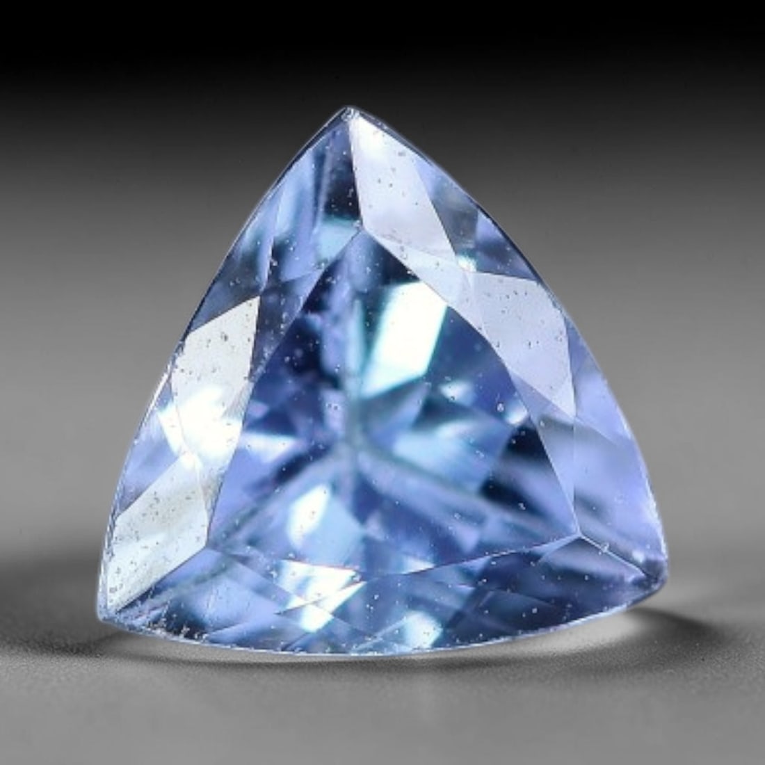 0.48 Carats Natural Soft Lavender Blue Trillion Tanzanite Brilliant Cut Loose Gemstone, 18XV: Natural delicate lavender-blue tanzanite expert trillion triangular brilliant cut loose gemstone, intricate multi-faceted layout delivers crisp, cool light sparkle, showcasing signature soft violet-bl