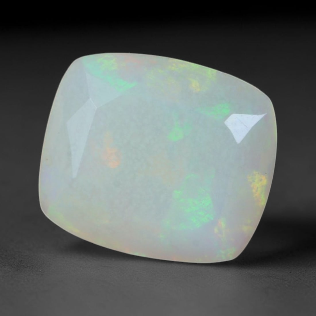 1.40 Carats Natural Ethiopian Welo Cushion Faceted Opal Loose Gemstone, 38XV: Natural milky translucent Ethiopian Welo opal crafted in soft cushion faceted cut, gentle mixed facets beautifully showcase scattered rolling play-of-color featuring bright lime green, soft golden yel