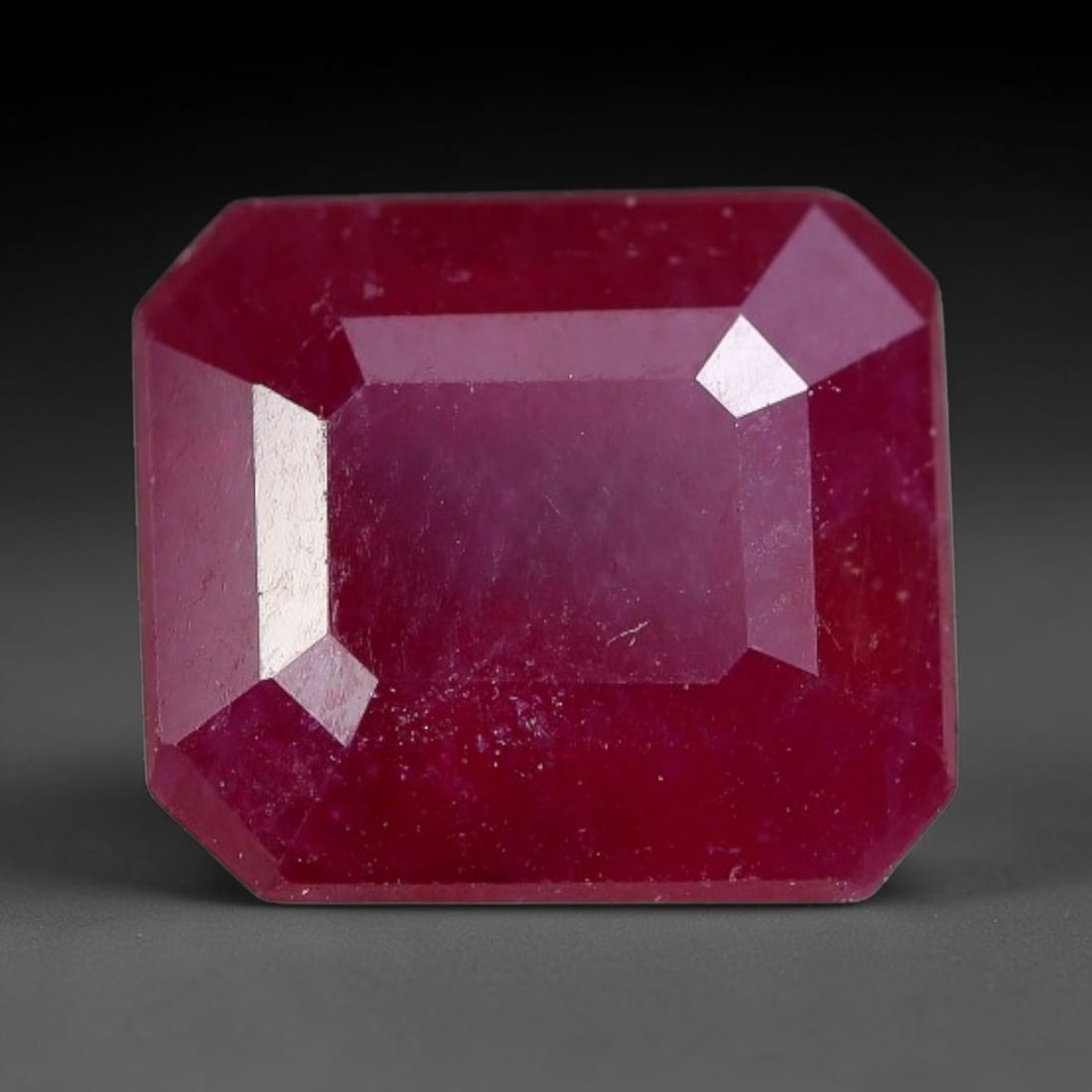 2.62 Carats Natural Madagascar Ruby Emerald Cut Loose Gemstone, 84XM: This natural Madagascar ruby is fashioned in a traditional emerald step faceted cut, showcasing deep saturated red tones typical of Malagasy corundum. Distinct natural internal fissures, fine mineral 