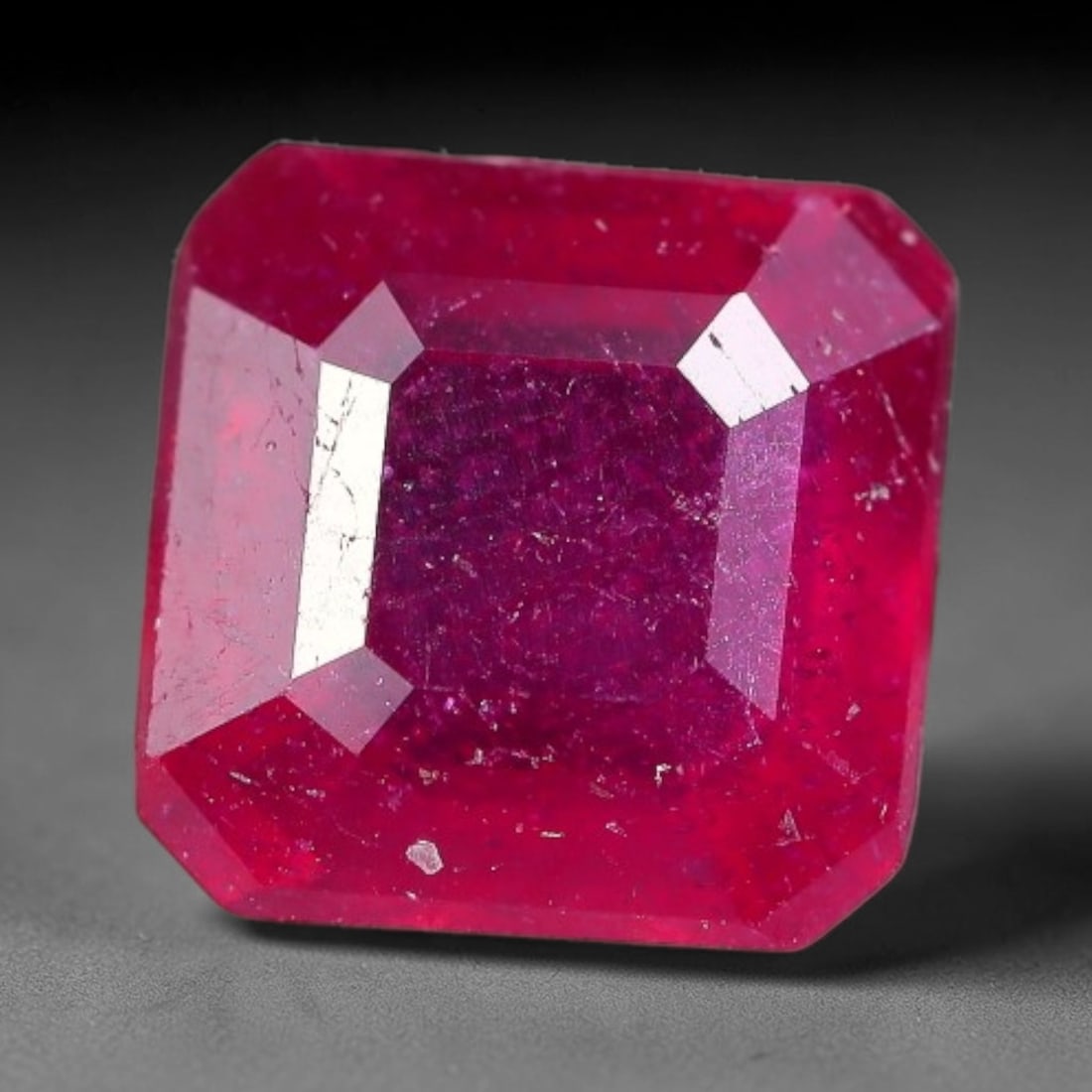 1.96 Carats Natural Madagascar Ruby Square Cushion Cut Loose Gemstone, 66XM: This natural Madagascar ruby is crafted into a square cushion modified step cut, displaying vivid saturated crimson red color typical of Malagasy corundum. Fine scattered mineral inclusions, subtle in
