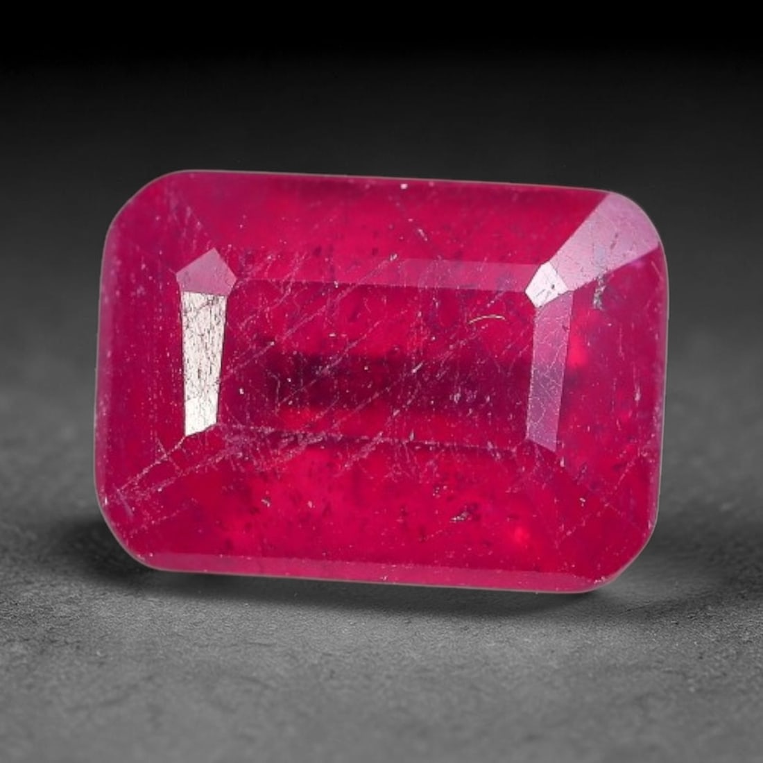 1.71 Carats Natural Madagascar Ruby Emerald Cut Loose Gemstone, 72XM: This natural Madagascar ruby is fashioned in a traditional emerald step faceted cut, showcasing deep saturated red tones typical of Malagasy corundum. Distinct natural internal fissures, fine mineral 