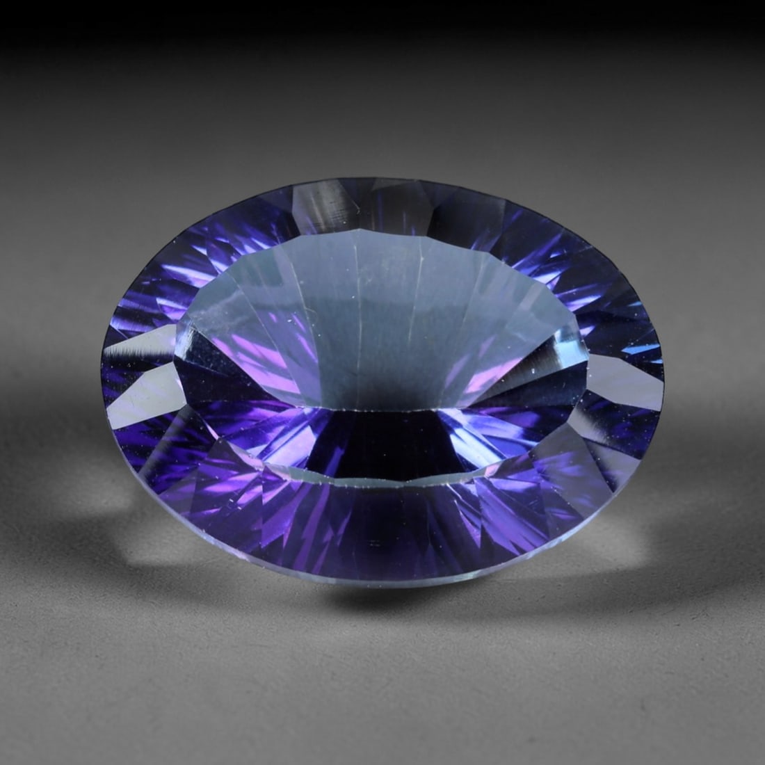 19.62ct Natural Purple Violet Topaz Oval Loose Faceted Gemstone, LZ541: This natural oval faceted topaz weighs 19.62 carats with precise dimensions of 19.5x14.7x9.6mm. It boasts a mesmerizing gradient purple-violet color scheme, featuring deep saturated royal purple along