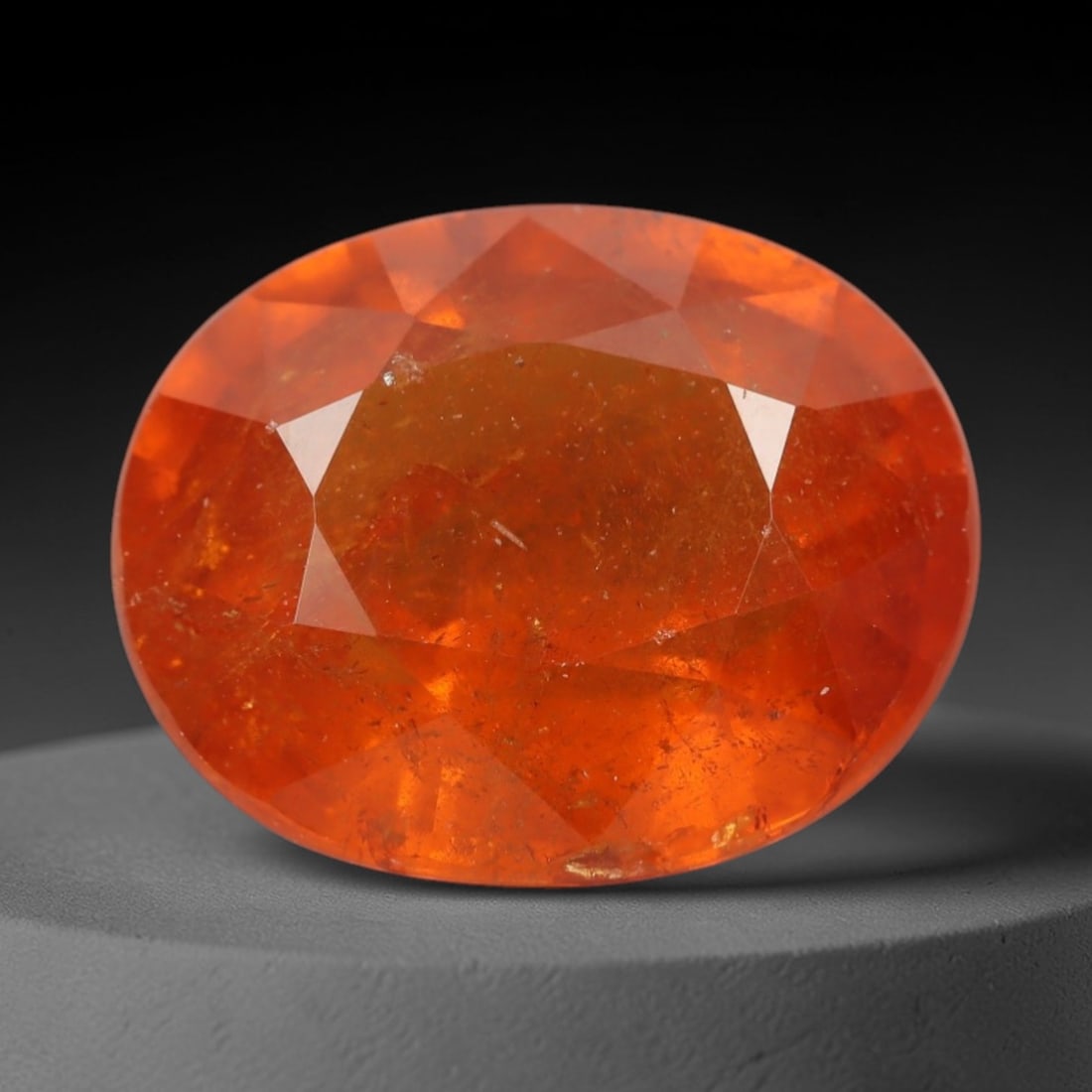 5.04ct Natural Mandarin Garnet Oval Loose Faceted Gemstone, LZ296: This natural oval faceted mandarin garnet weighs 5.04 carats with precise dimensions of 11.0x8.9x5.0mm. It showcases an intense, vivid saturated mandarin orange hue with fiery tangerine undertones, em
