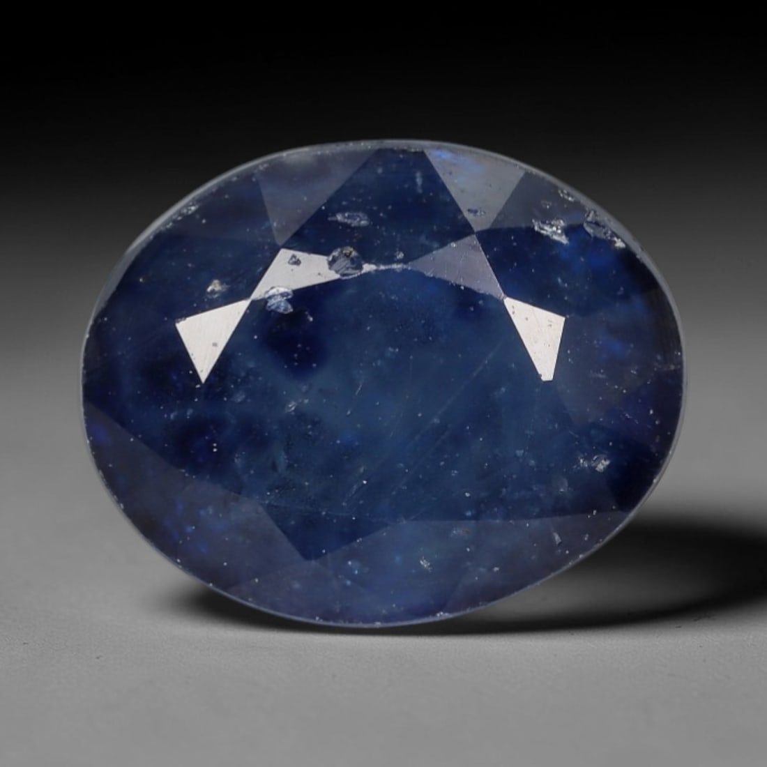 2.83ct Natural Muted Royal Blue Sapphire Oval Loose Faceted Gemstone, LZ300: This natural oval faceted sapphire weighs 2.83 carats with precise dimensions of 8.7x7.0x5.2mm. It showcases a soft muted royal blue main tone, blended with pale grey-blue translucent outer layers, fe