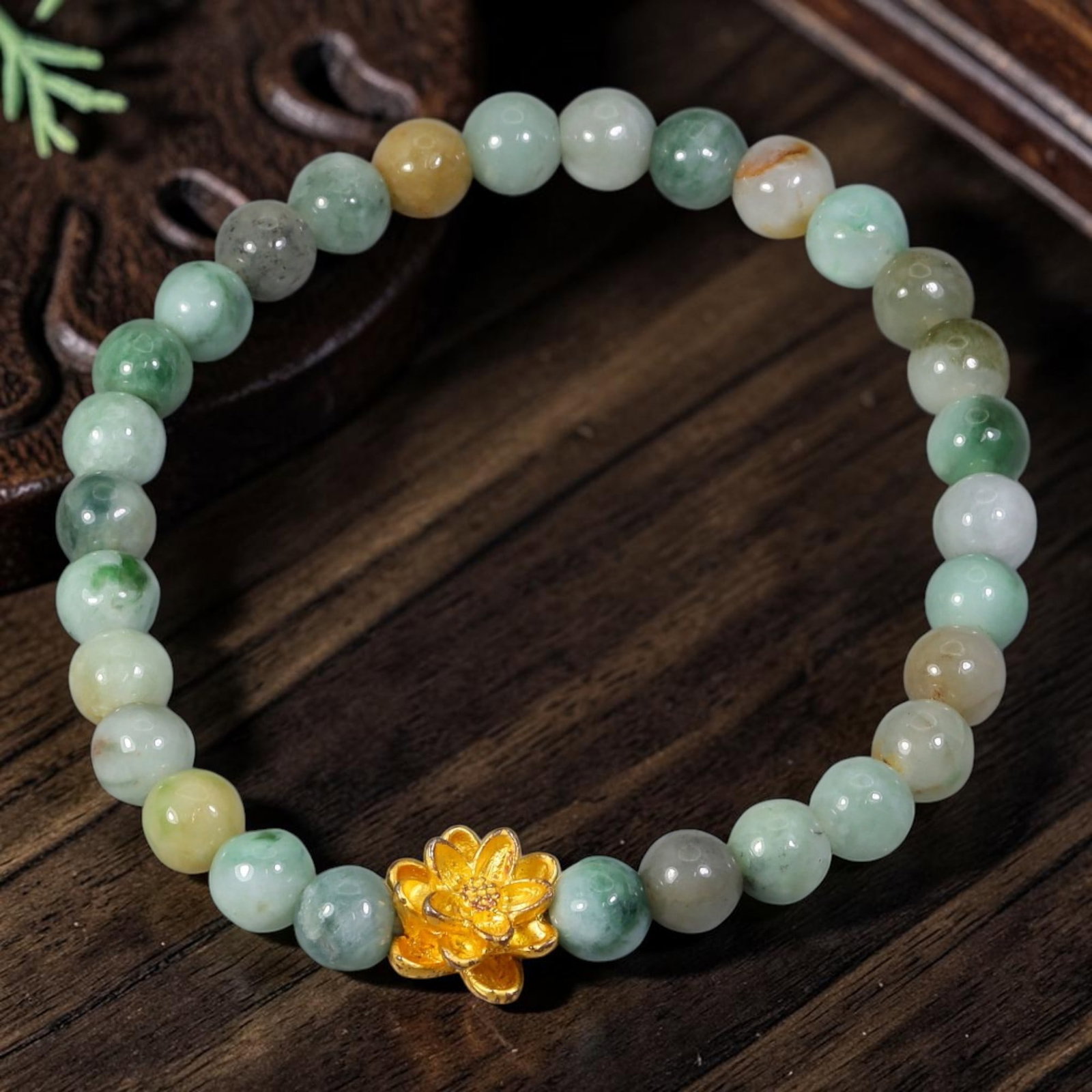 Natural Burmese Type A Jadeite Jade Stretch Bracelet - Gold Lotus Flower Focal Charm, 91YG: This delicate stretch bracelet is hand-strung with smooth round natural untreated Burmese Type A jadeite jade beads measuring 5.80 millimeters. The genuine jade beads showcase a mixed natural palette 