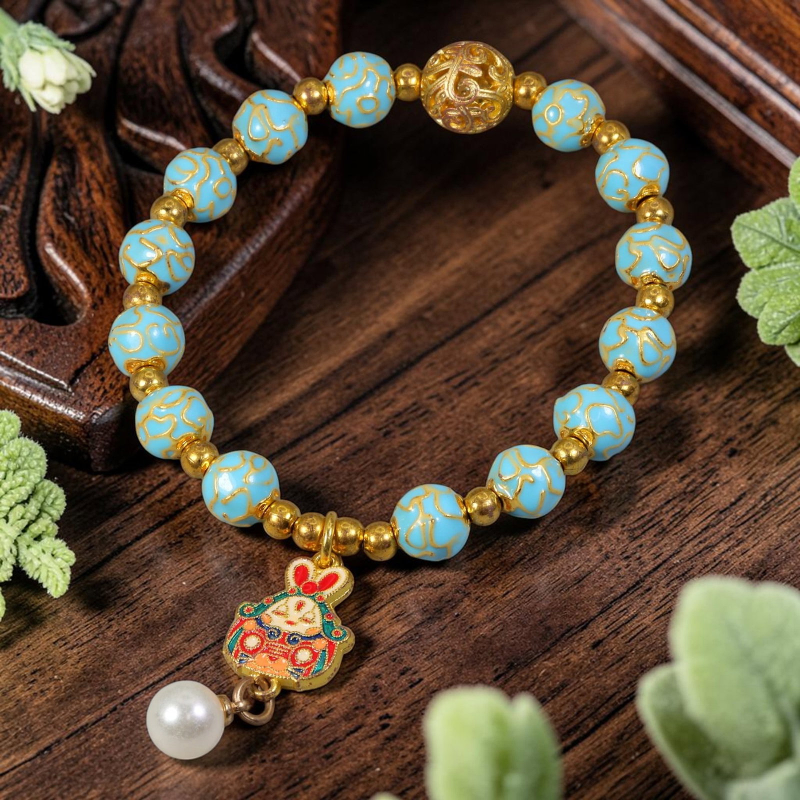 Chinese Cloisonne Enamel Beaded Bracelet - Sky Gold Rabbit Zodiac Charm, 87YG: This modern Chinese revival stretch bracelet uses round cloisonne enamel beads measuring 8.10 millimeters, coated in soft sky blue enamel detailed with raised gold-tone swirling cloud patterns. Tiny p