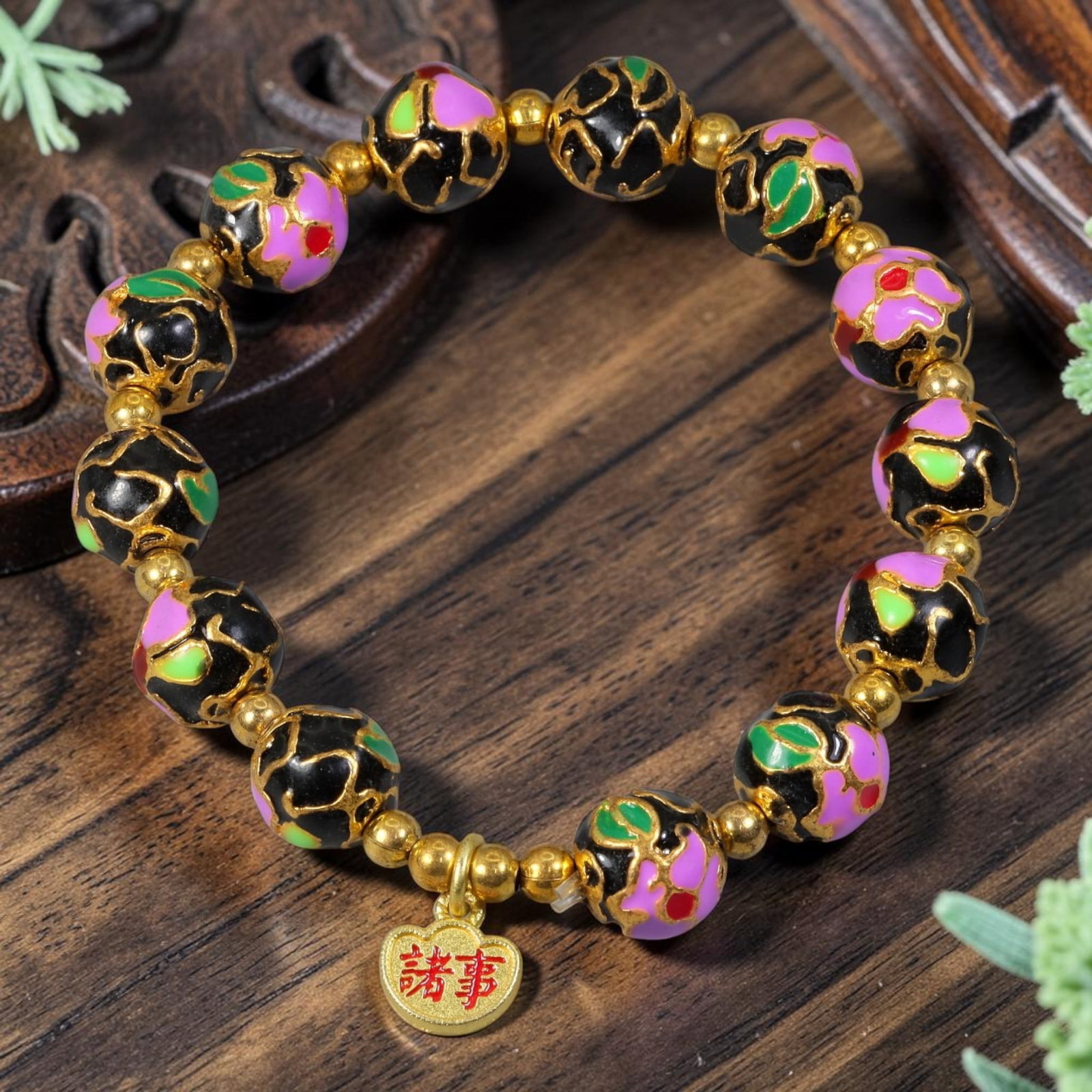 Chinese Cloisonne Enamel Beaded Bracelet - Black Gold All Wishes Charm, 85YG: This modern Chinese revival stretch bracelet features round cloisonne enamel beads measuring 10.40 millimeters, finished with glossy black enamel inlaid with pink, green and red floral sections outlin