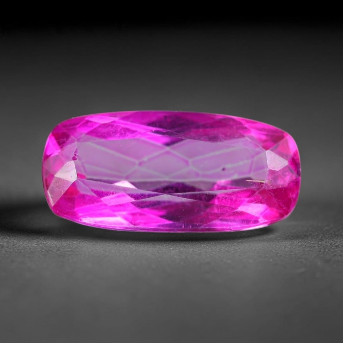 5.33 Carats Natural Vivid Pink Topaz Long Cushion Faceted Loose Gemstone, 13WS: This sleek long cushion faceted pink topaz showcases vivid saturated hot pink color glowing through precisely polished step facets, with faint tiny natural internal fine inclusions visible within the 