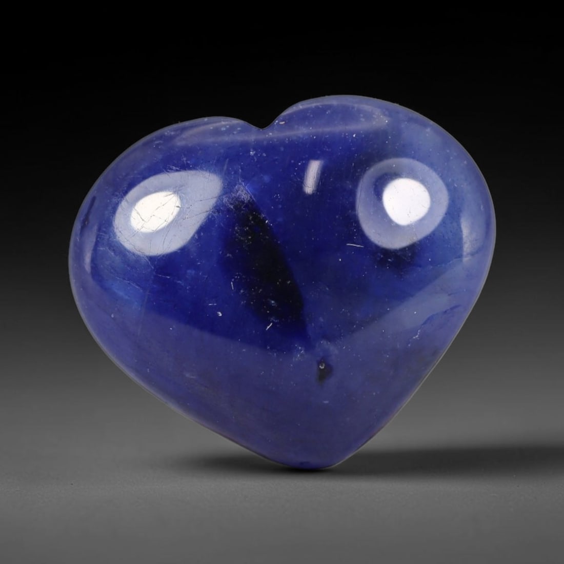 12.03 Carats Natural Madagascar Deep Royal Blue Heated Sapphire Heart Cabochon Loose Gemstone, 27WS: This rich deep royal blue sapphire cabochon holds dense saturated navy-blue hues across its smooth polished heart domed surface, with scattered dark mineral flecks and delicate fine silk veining natur
