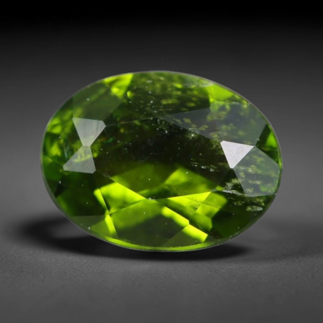 1.36 Carats Natural Vivid Chrome Green Chrome Diopside Oval Faceted Loose Gemstone, 46WS: This striking chrome diopside faceted oval stone showcases vivid intense chrome green color illuminated through crisp polished step facets, with fine tiny natural mineral speckles visible within the t