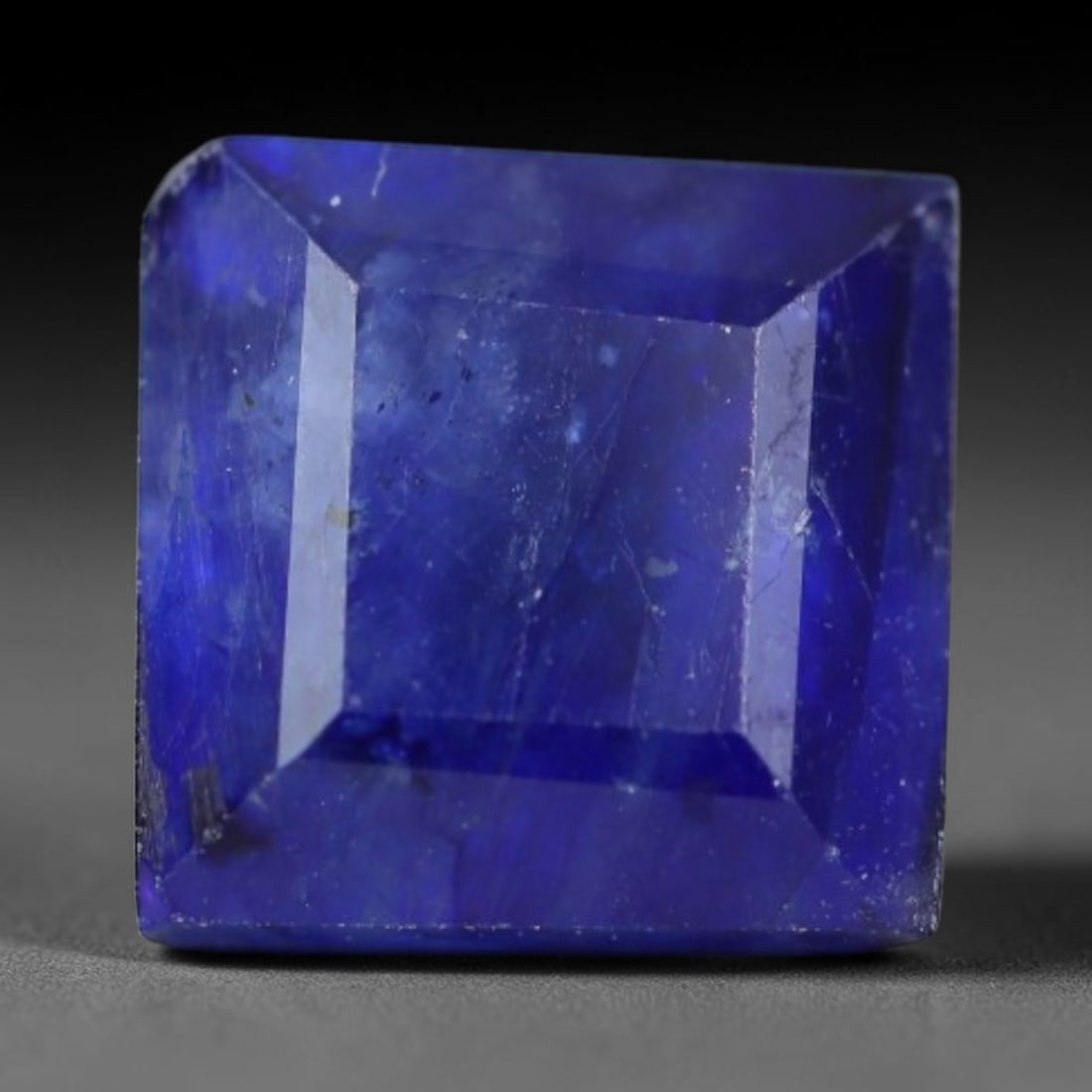 2.86 Carats Royal Blue Sapphire Square Emerald Cut Loose Gemstone, 33WS: This neat square emerald cut sapphire showcases deep, saturated royal blue color, enhanced by clean reflective step facets. Natural internal fine fissures and scattered tiny mineral specks can be obse