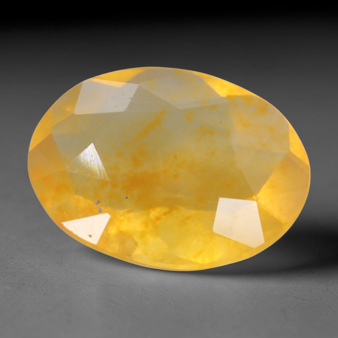 2.93 Carats Golden Yellow Fire Opal Oval - Natural Mexican Stone, 85XC: This luminous oval-cut Mexican fire opal captivates with its warm, honeyed yellow body tone, punctuated by subtle fiery inclusions that dance across its surface. The stone's translucent base glows wit