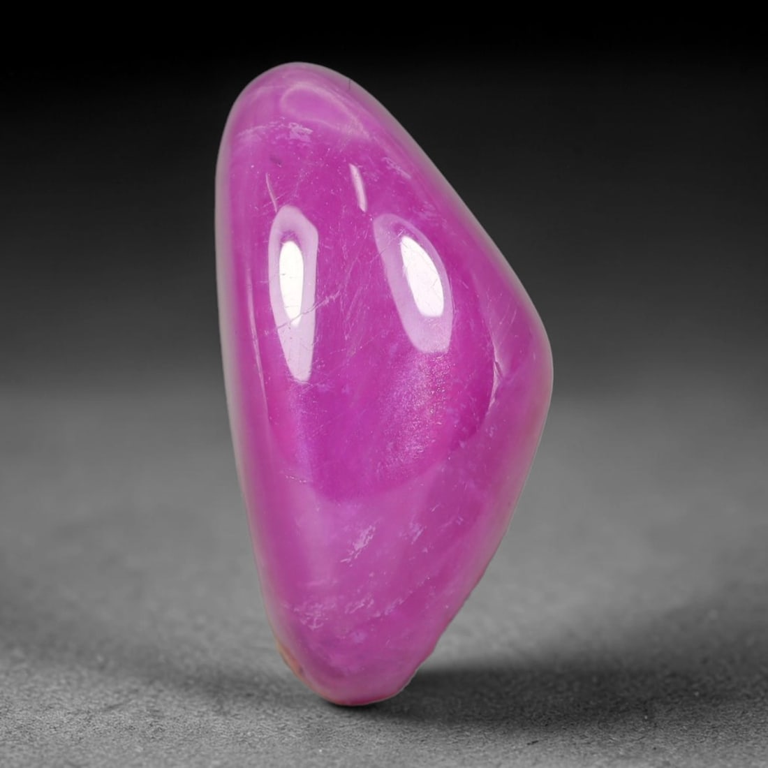 20.29 Carats Natural Madagascar Vivid Fuchsia Pink Heated Ruby Freeform Cabochon Loose Gemstone,: This striking fuchsia pink ruby cabochon holds rich saturated magenta-pink coloration across its polished domed surface, with faint natural mineral veining and subtle fine internal fractures visible w