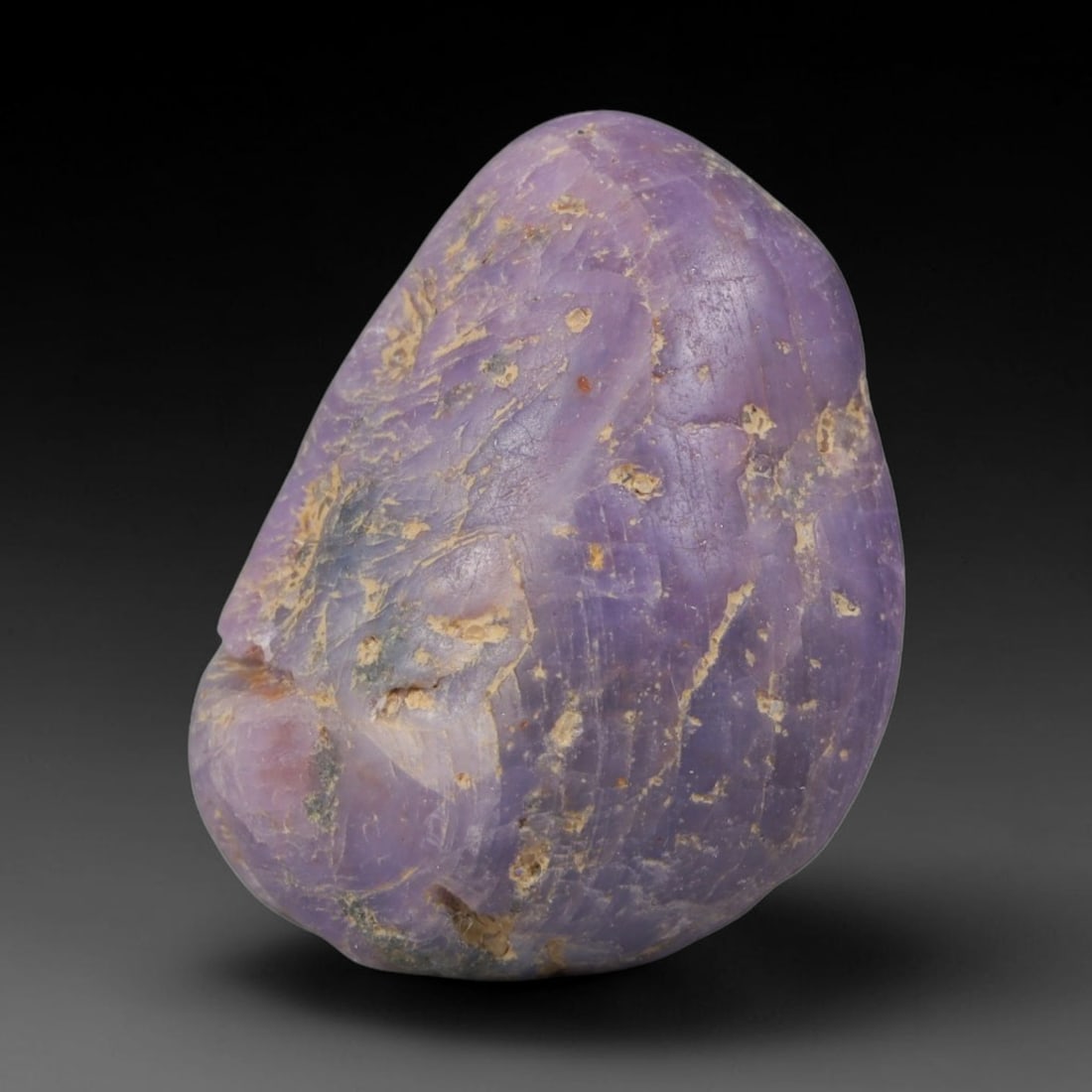 45ct Natural Unheated Sri Lankan Purplish Blue Sapphire Rough, 30YQ: This natural corundum rough is an unheated purplish blue sapphire sourced from Sri Lankan alluvial gem deposits, featuring an irregular natural native form with residual pale yellow-brown mineral matr