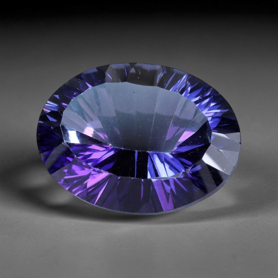18.87ct Natural Purple Violet Topaz Oval Loose Faceted Gemstone, LZ542: This natural oval faceted topaz weighs 18.87 carats with precise dimensions of 19.1x14.7x9.3mm. It boasts a mesmerizing gradient purple-violet color scheme, featuring deep saturated royal purple along