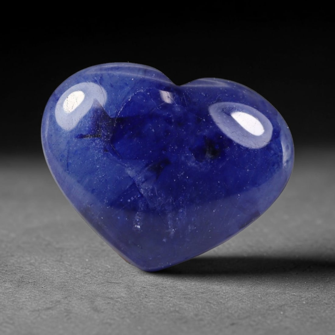 9.01 Carats Natural Madagascar Deep Royal Blue Heated Sapphire Heart Cabochon Loose Gemstone, 31WS: This rich deep royal blue sapphire cabochon features dense saturated navy blue tones across its smooth polished heart domed surface, with scattered natural dark mineral flecks and fine silk crystallin
