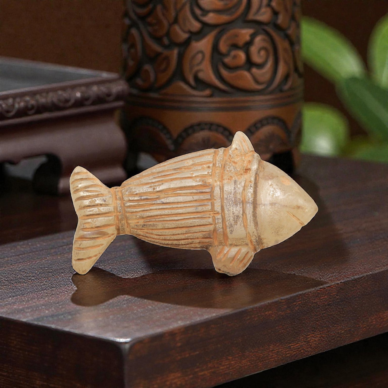 Ancient Chalcedony Fish - Zoomorphic Amulet Figurine, 64ZP: This zoomorphic amulet is carved from translucent chalcedony, shaped into a stylized fish form with incised linear details defining the segmented body, fins, and tail, alongside a small incised eye an