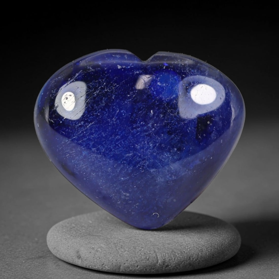 8.86 Carats Natural Madagascar Deep Royal Blue Heated Sapphire Heart Cabochon Loose Gemstone, 30WS: This rich deep royal blue sapphire cabochon carries dense saturated navy-blue color filling its polished domed heart silhouette, dotted with fine natural mineral silk inclusions and faint crystalline 