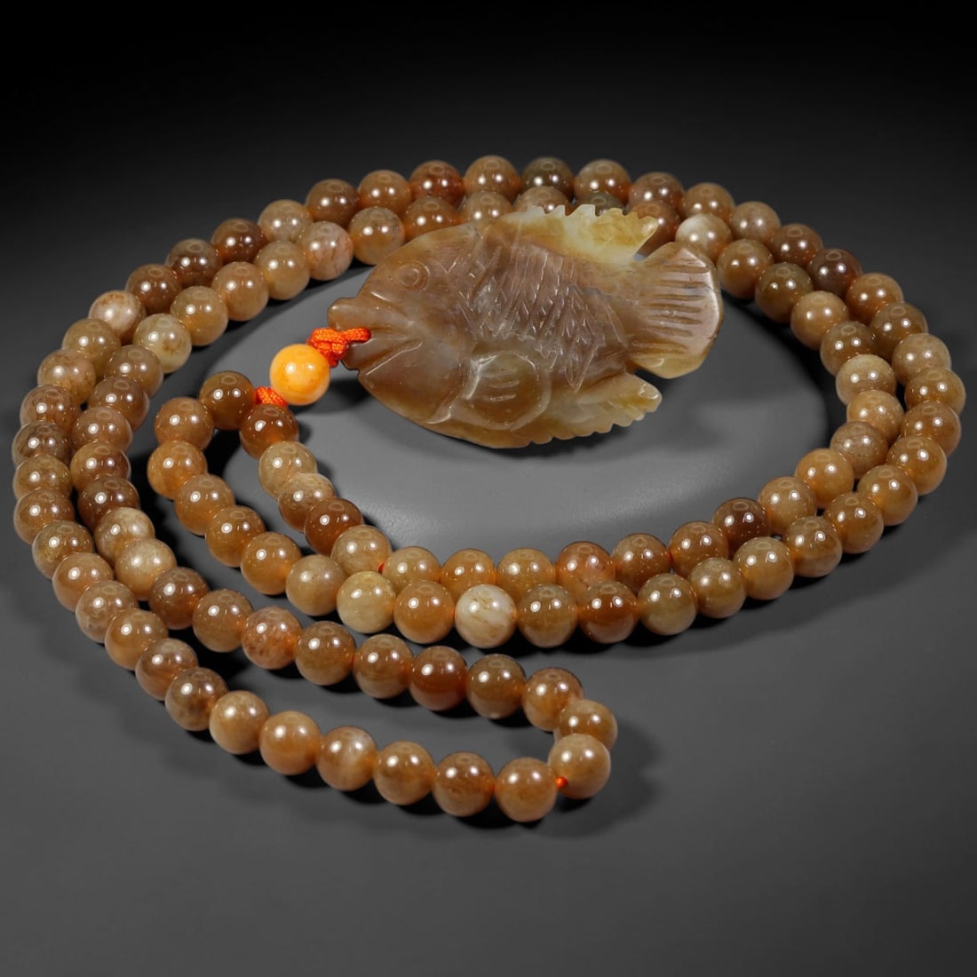 Burmese Jadeite Beaded Necklace with Hetian Sugar Jade Fish Pendant, 100WJ: This necklace features a carved fish pendant made from natural Hetian sugar jade, paired with matching round Hetian sugar jade beads. The pendant is crafted from warm caramel-toned sugar jade, depicti