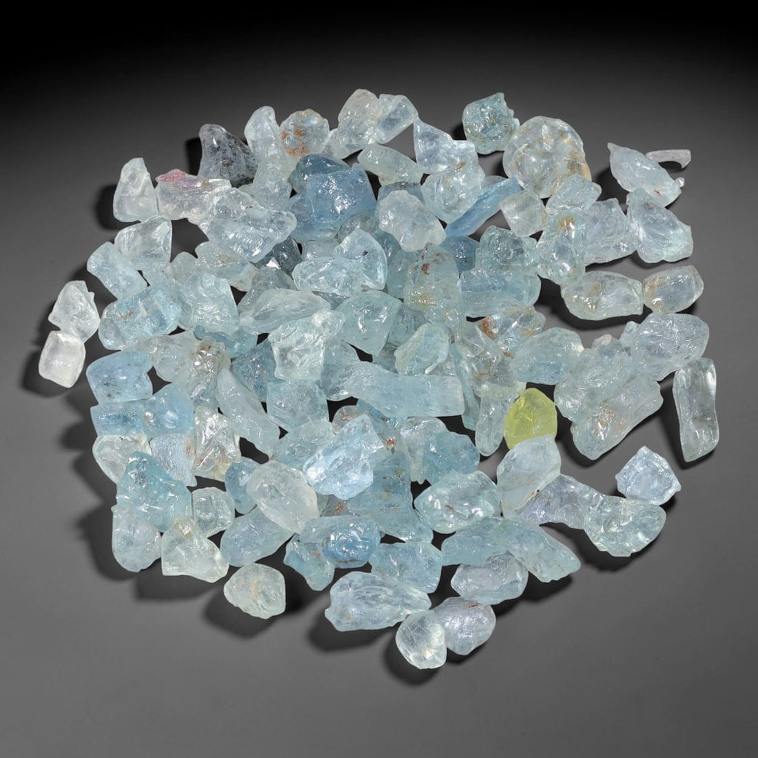 112.76 Carats Natural Aquamarine Rough Parcel, 60WT: This luminous parcel of natural aquamarine rough showcases the classic soft sky-blue hue the gem is known for, ranging from pale, translucent tones to deeper, more saturated blues. The stones are in t
