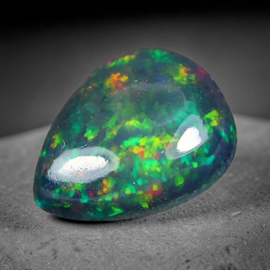 1.56ct Natural Ethiopian Welo Black Smoked Opal Cabochon Loose Gemstone, 85WP: This fully polished Ethiopian Welo opal features a dark smoked base with vivid, sweeping play-of-color shifting across its glossy dome surface, measured at 10.4x7.9x3.9mm. The black smoke treatment de