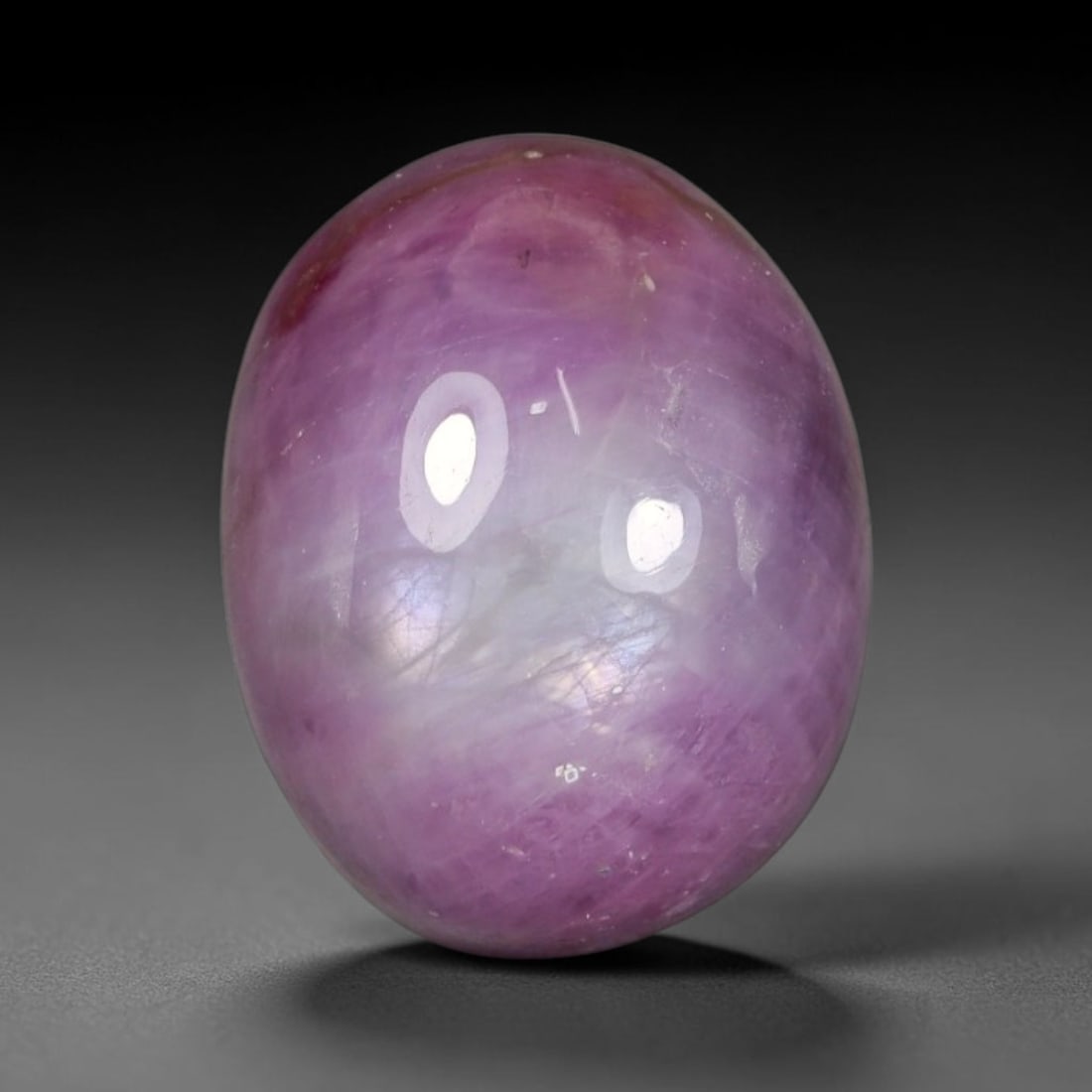 12.70 Carats Natural Lavender Pink Ruby Oval Cabochon Loose Gemstone, 93WS: This polished oval cabochon ruby boasts a soft translucent lavender-pink hue with beautiful natural marbled color zoning, mixing rich magenta-pink streaks with milky pale pastel undertones. Silky thin