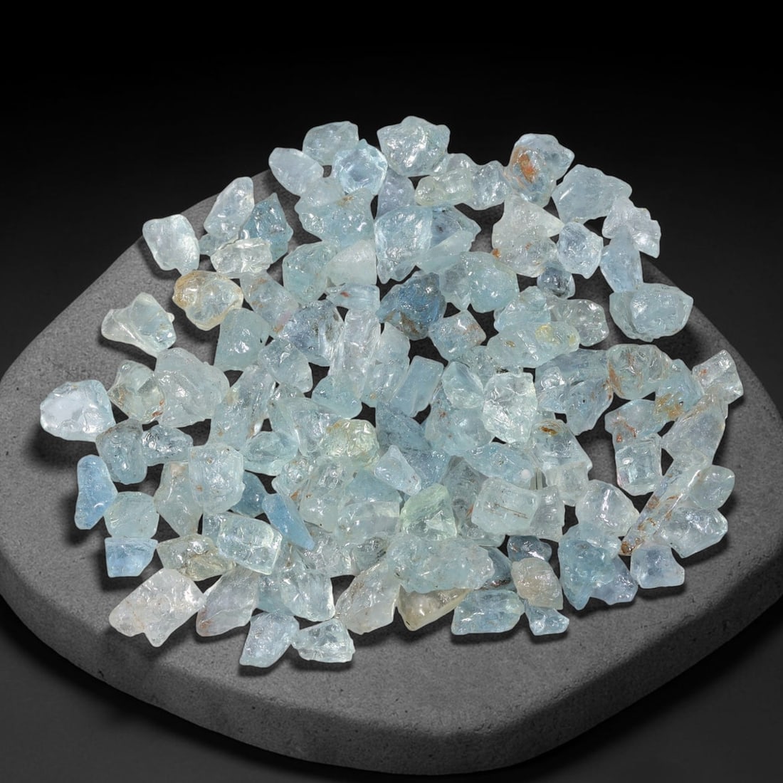 114.63 Carats Natural Aquamarine Rough Parcel, 58WT: This luminous parcel of natural aquamarine rough showcases the classic soft sky-blue hue the gem is known for, ranging from pale, translucent tones to deeper, more saturated blues. The stones are in t