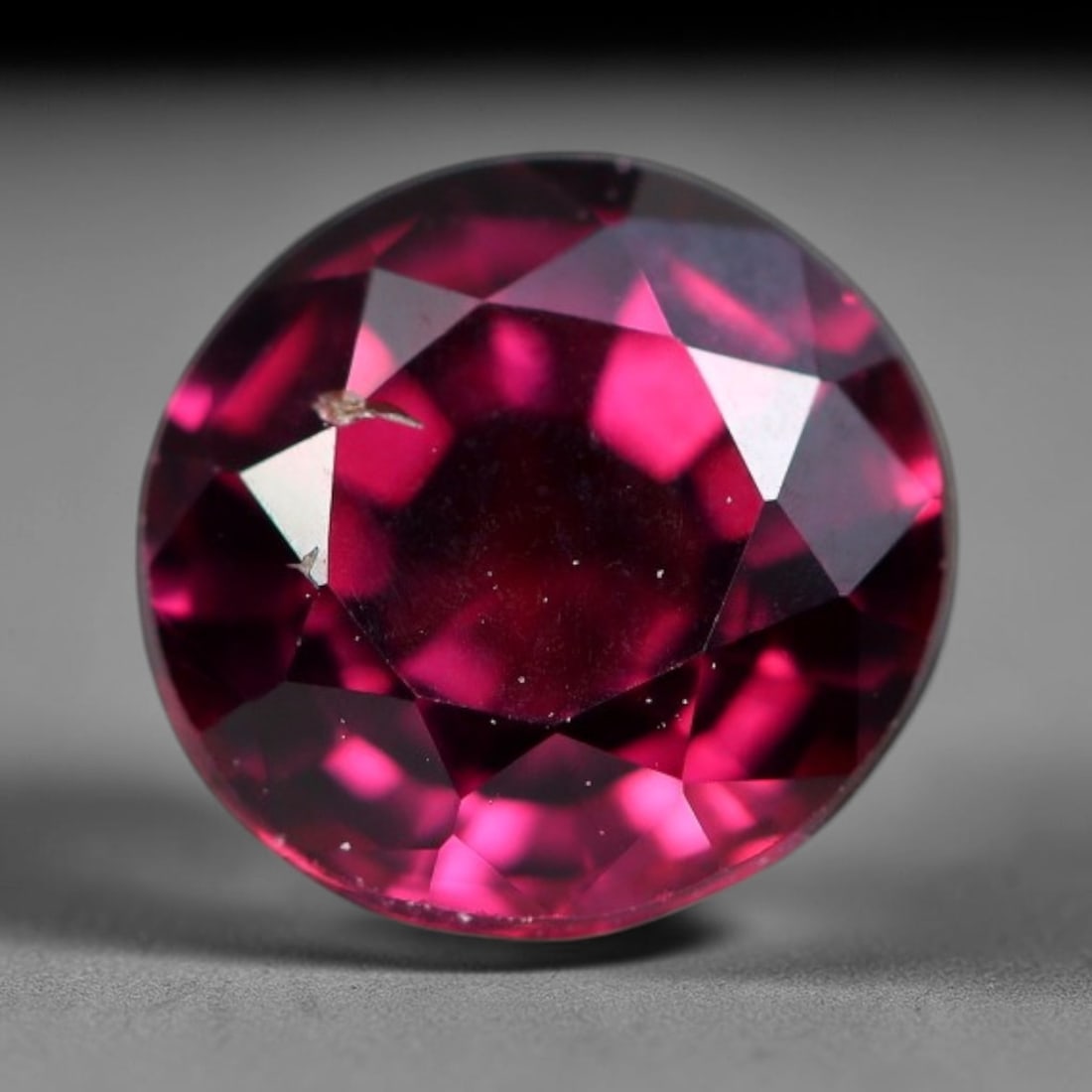 1.70 Carats Natural Vivid Raspberry Pink Garnet Round Brilliant Loose Gemstone, 65WS: This classic round brilliant faceted garnet radiates a stunning saturated raspberry pink-red hue, bursting with bright vivid fire across its precisely cut reflective facets. Small natural mineral micr