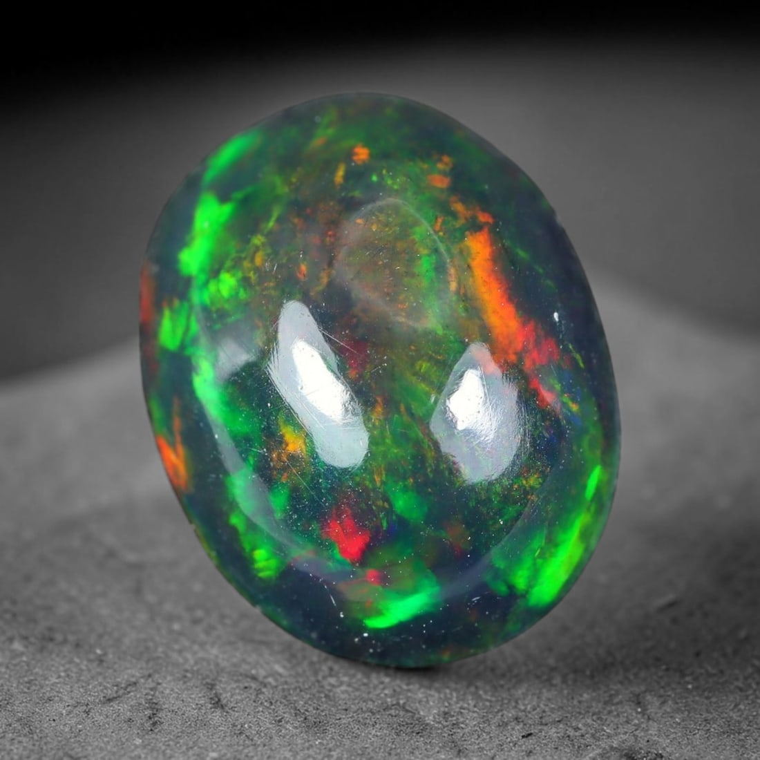 2.52ct Natural Ethiopian Welo Black Smoked Opal Cabochon Loose Gemstone, 87WP: This fully polished Ethiopian Welo opal features a dark smoked base with vivid, sweeping play-of-color shifting across its glossy dome surface, measured at 11.4x8.7x5.3mm. The black smoke treatment de