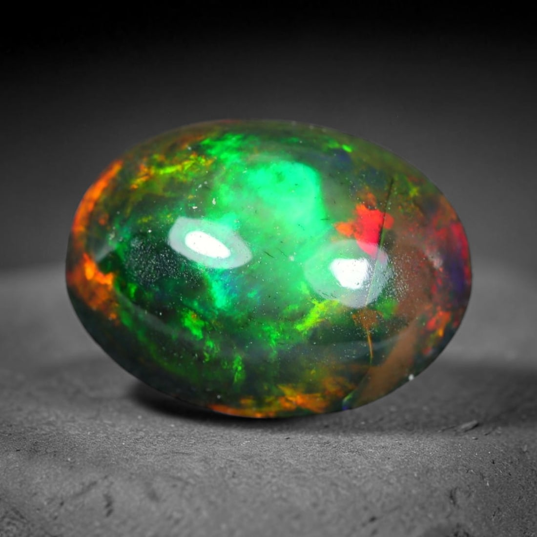 2.13ct Natural Ethiopian Welo Black Smoked Opal Cabochon Loose Gemstone, 88WP: This fully polished Ethiopian Welo opal features a dark smoked base with vivid, sweeping play-of-color shifting across its glossy dome surface, measured at 10.8x8.3x4.9mm. The black smoke treatment de