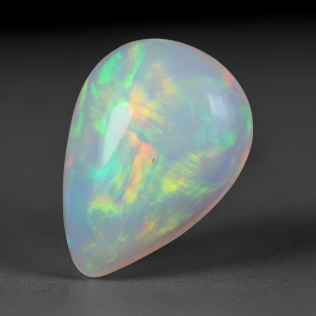 2.28 Carats Natural Ethiopian Welo Opal Oval Cabochon Loose Gemstone, 41XV: Natural Ethiopian Welo opal polished oval cabochon loose gemstone, luminous translucent milky white base stone with vivid multi-hued play-of-color featuring bright emerald green, lime yellow, soft blu
