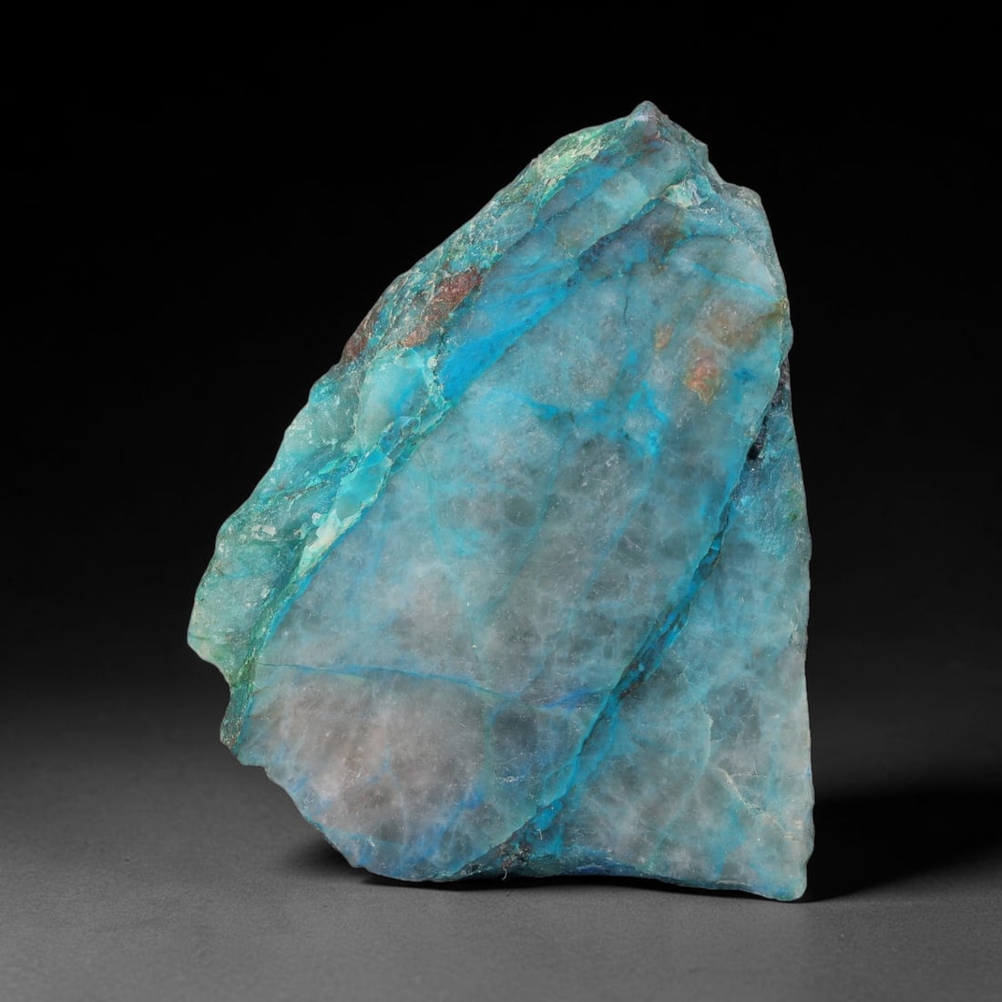 129ct Natural Peruvian Chrysocolla Polished Slab Rough, 34WV: This partial-polished chrysocolla slab features blended mineral matrix with smooth refined face and unaltered natural rugged edge across its 51x41x7mm elongated form, translucent mineral layers hold s