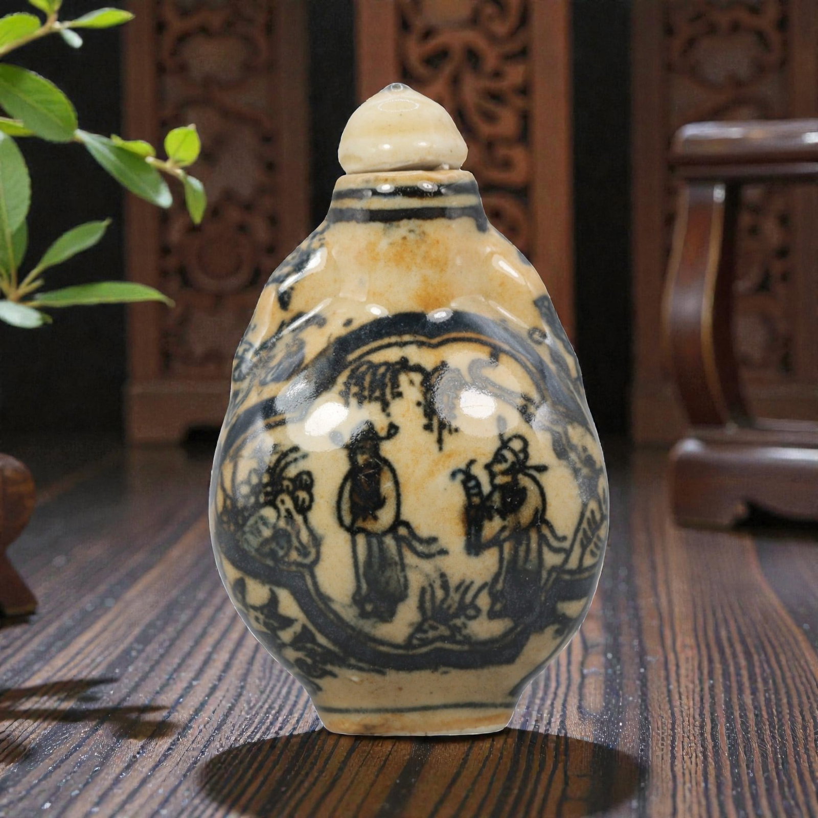 A Chinese Porcelain Snuff Bottle, 20th Century, 5YD: Crafted from porcelain with a creamy white glaze base and decorated in underglaze blue, the snuff bottle features an ovoid body with a short neck and a conforming stopper. The main body is adorned wit