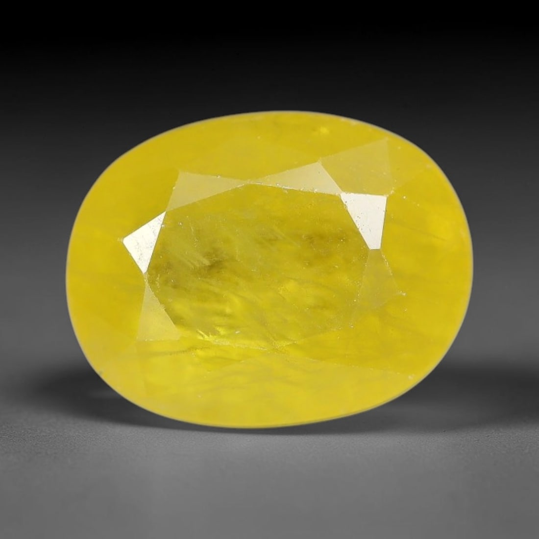 3.63 Carats Natural Yellow Sapphire Oval Faceted Loose Gemstone, 55XM: This natural yellow sapphire features a classic oval brilliant faceted cut, holding consistent warm golden-yellow color throughout the corundum crystal. Fine microscopic mineral specks and faint natur