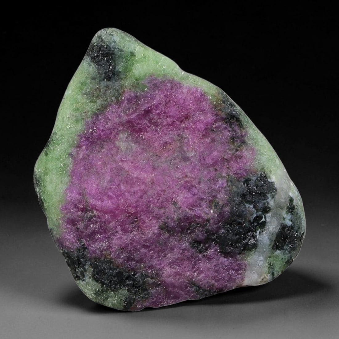52ct Natural Tanzanian Ruby Zoisite Raw Rough Specimen Mineral Stone, 23YQ: This unpolished mineral rough is natural ruby zoisite sourced from Tanzania, exhibiting distinct banded mineral segregation of vibrant green zoisite, magenta ruby crystals, and dark hornblende inclusi