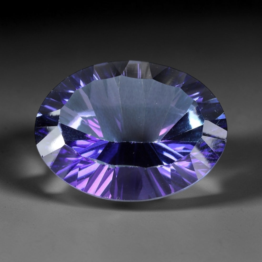 16.10ct Natural Purple Violet Topaz Oval Loose Faceted Gemstone, LZ540: This natural oval faceted topaz weighs 16.10 carats with precise dimensions of 18.4x14.1x8.7mm. It boasts a mesmerizing gradient purple-violet color scheme, featuring deep saturated royal purple along