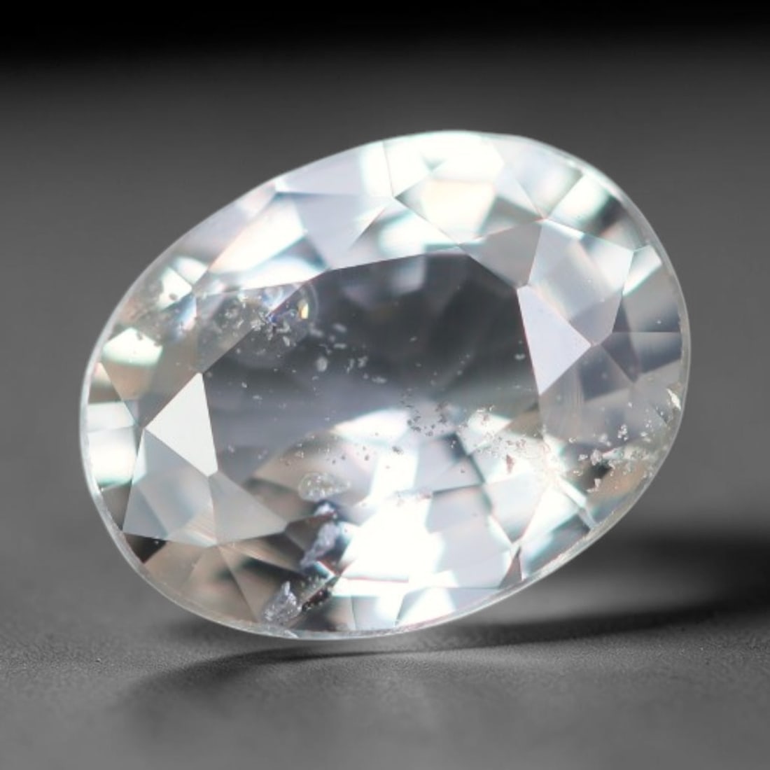 0.52 Carats Natural White Sapphire Oval Faceted Loose Gemstone, 67XV: Natural colourless white corundum sapphire expertly cut into an oval faceted loose gemstone, crafted with mixed brilliant facets to deliver bright light refraction. The crystal is transparent with sca