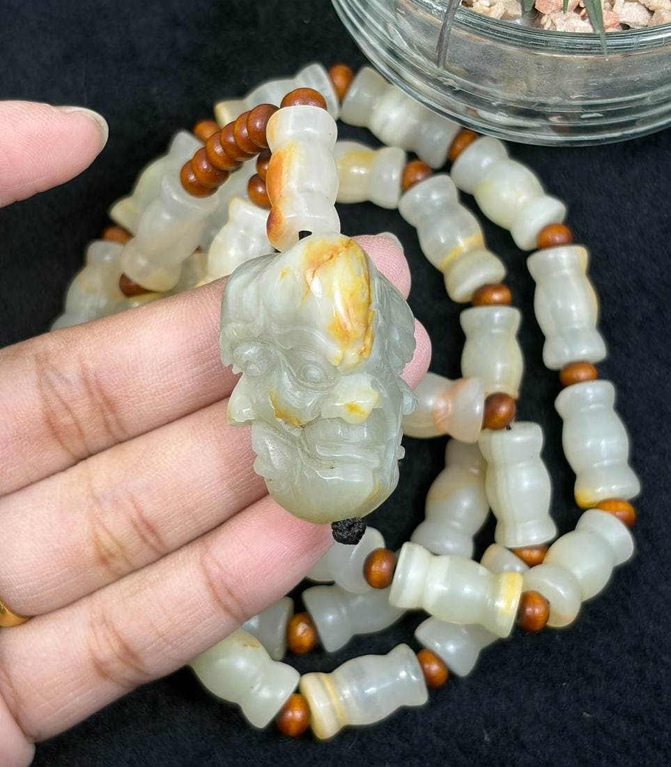 Natural Xinjiang Hetian Jade Luohan Head Pendant Necklace - Chinese Carved Amulet, 89YJ: This necklace features a natural Xinjiang Hetian jade luohan head pendant paired with matching Hetian jade beads, accented with small wooden spacers. The pendant is carved from pale Hetian jade with d