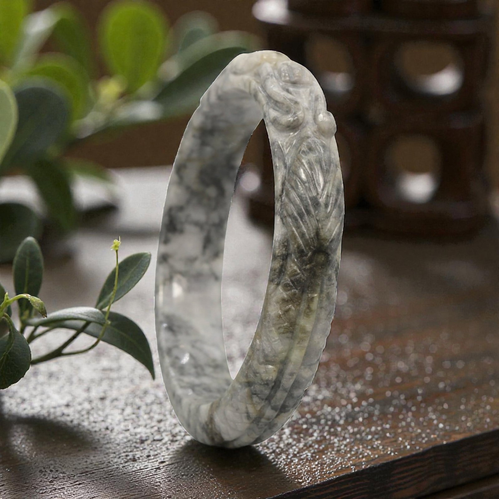 Natural Burmese Type A Carved Jadeite Jade Bangle Bracelet, 78ZL: A fine jadeite bangle of circular form, masterfully carved in relief with a continuous band of a sinuous dragon coiling around its circumference. The stone exhibits a striking variegated palette, with