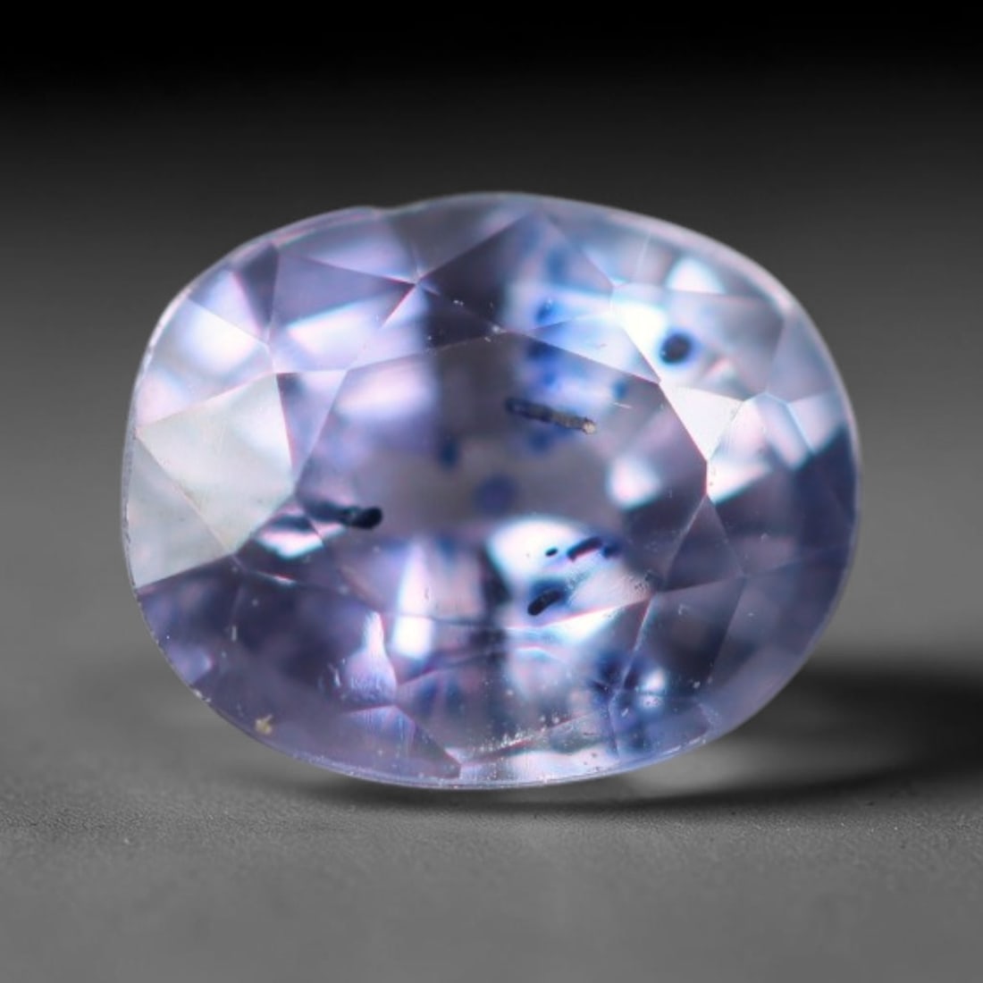 0.42 Carats Natural Pale Lavender Sapphire Loose Faceted Gemstone, 22XM: Natural muted pale lavender corundum sapphire finely faceted loose gemstone, brilliant mixed facets boost soft light sparkle and showcase its delicate translucent lilac tone. Distinct dark needle and 