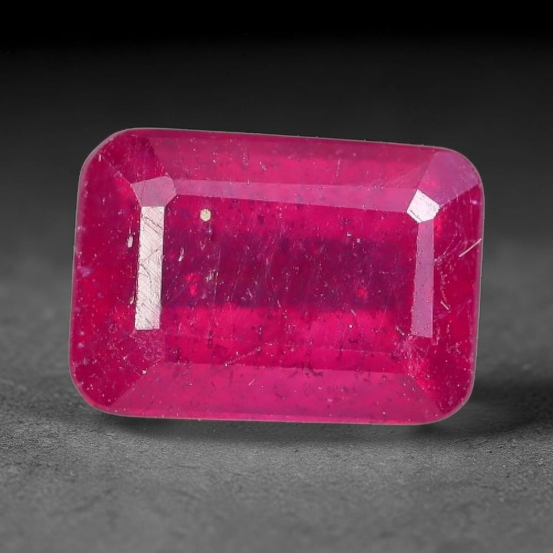 1.51 Carats Natural Madagascar Ruby Emerald Cut Loose Gemstone, 75XM: This natural Madagascar ruby is fashioned in a traditional emerald step faceted cut, showcasing deep saturated red tones typical of Malagasy corundum. Distinct natural internal fissures, fine mineral 