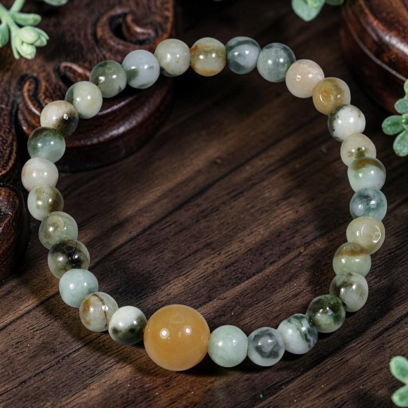 Natural Burmese Type A Jadeite Jade Stretch Bracelet - Large Honey Yellow Jade Focal Bead, 89YG: This delicate stretch bracelet is crafted with smooth round natural untreated Burmese Type A jadeite jade beads measuring 5.90 millimeters. The small jade beads feature natural flowing floating green,